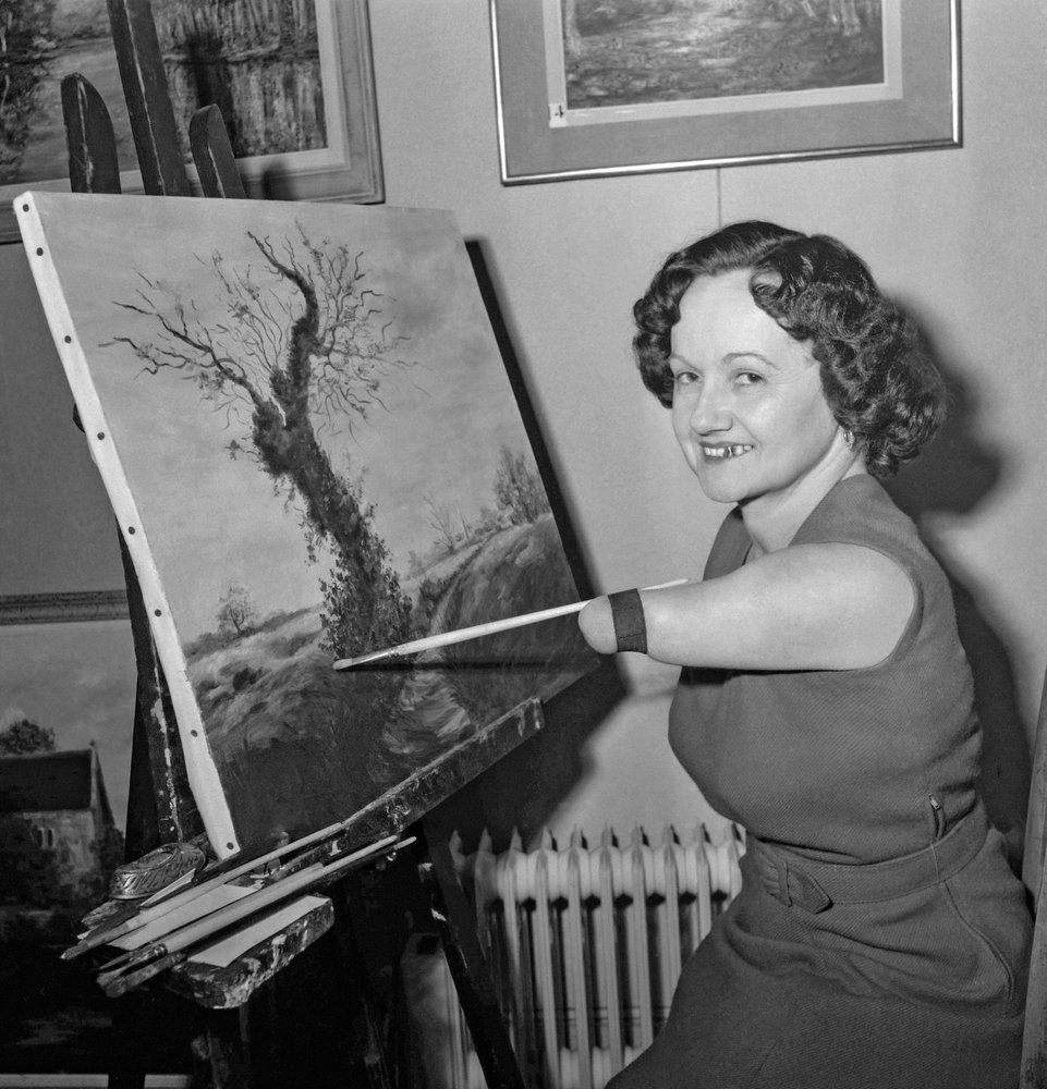Denise Legrix, born without legs nor forearm, painting a canvas, Paris, November 21, 1960 by Unknown