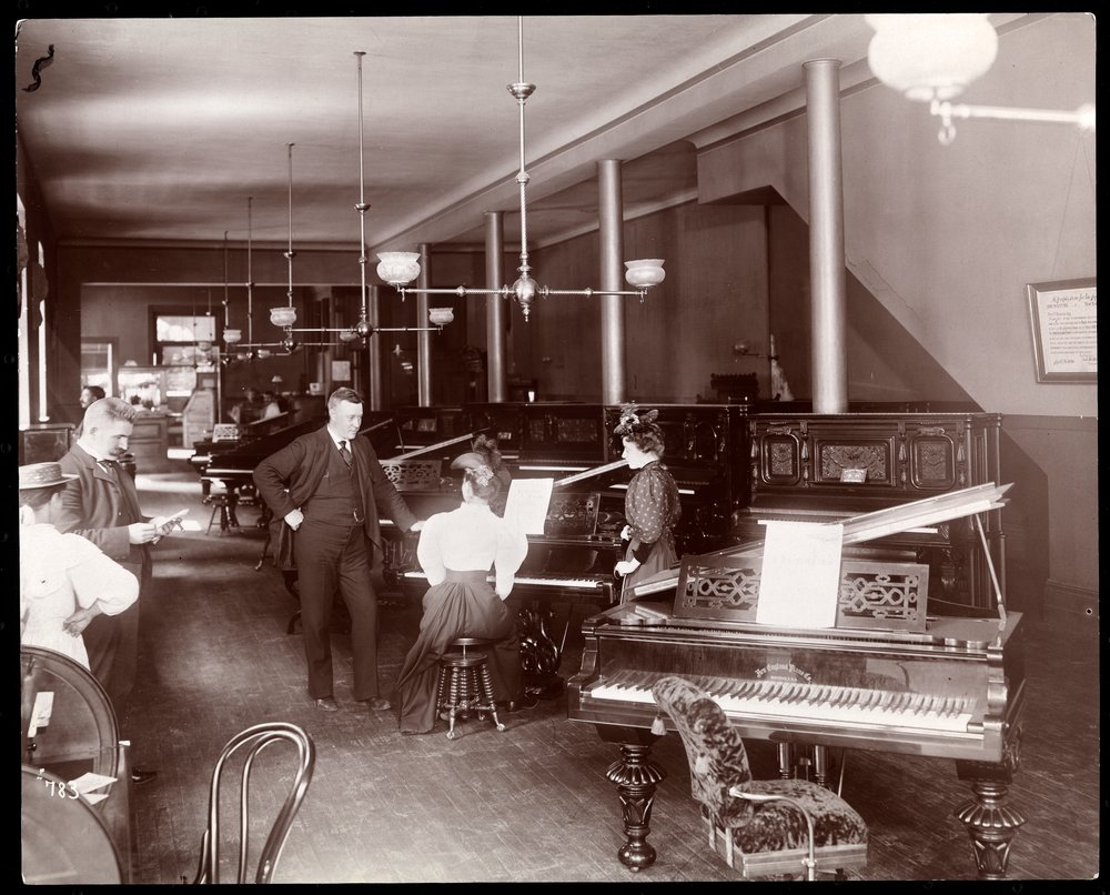 A showroom of the New England Piano Co., 1895 by Byron Company