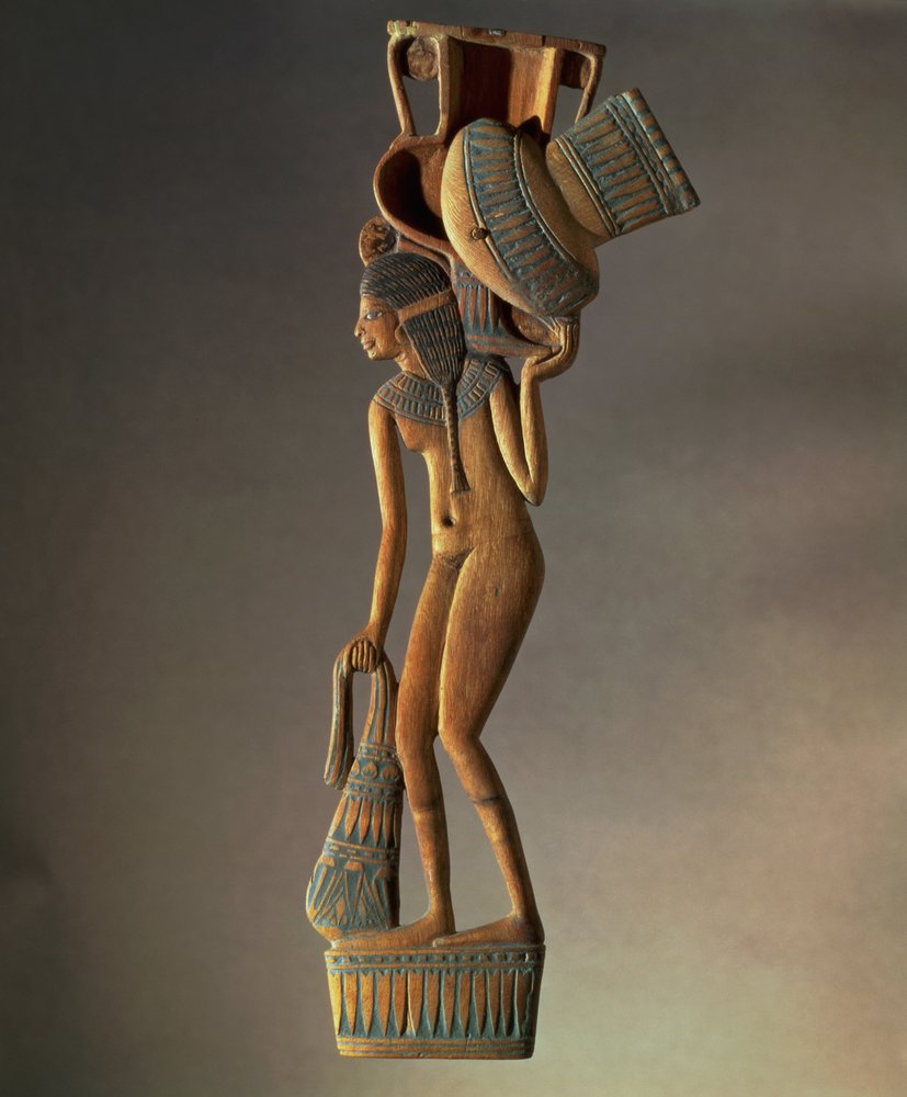 Spoon with a flattened handle in the shape of a young girl carrying a vessel which forms the lidded bowl, New Kingdom by Egyptian 18th Dynasty