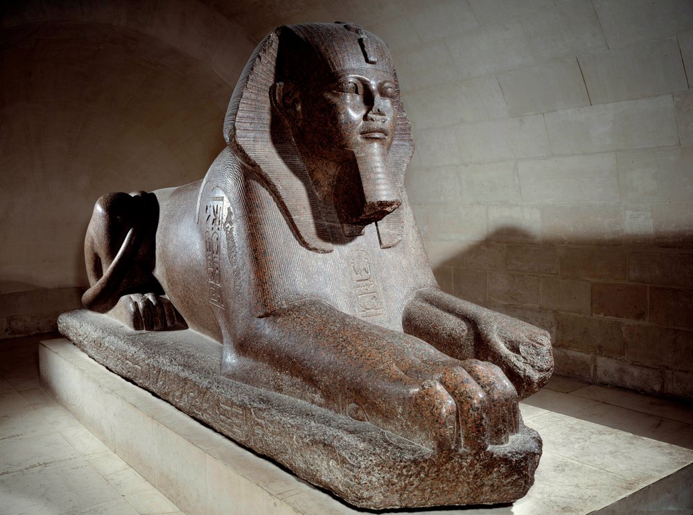 Egyptian Antiquity: the Great Sphinx, usurped by Ramses II and his son Merenptah I (or Mineptah, Merneptah). Pink granite sculpture. Paris, Louvre Museum by School Egyptian