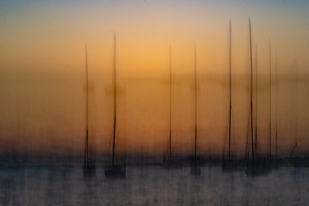 Blurred Sunset Sailboats by Franco Tessarolo