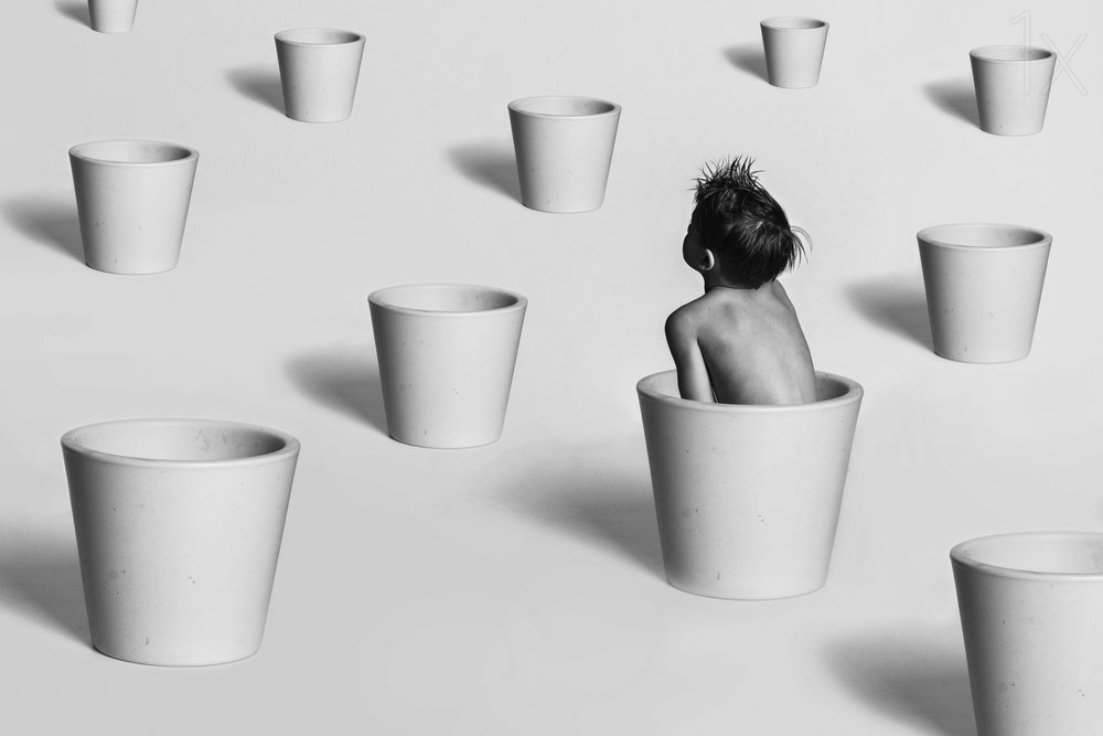 Child Among White Pots by Karim Aboukelela
