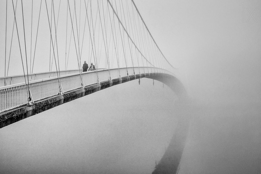 People on a Misty Bridge by Krunoslav Nevistic
