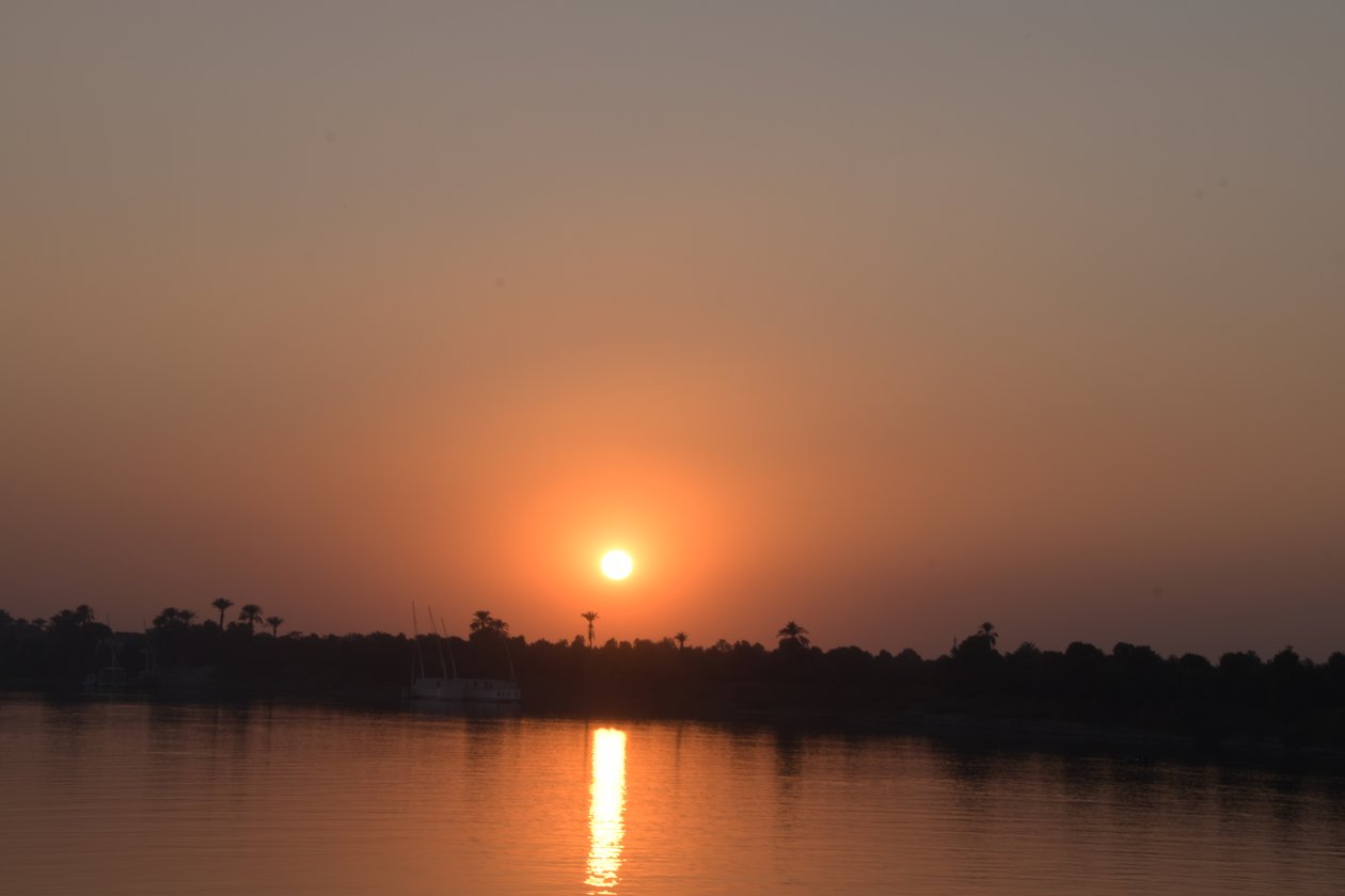Golden Sunset Reflections on a Tranquil River by Albert Mansour