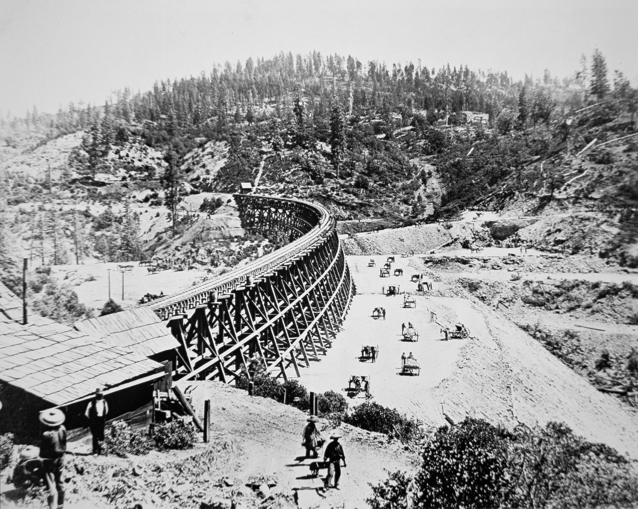 Chinese labourers working on a trestle bridge on the western slope of the Sierra Nevada mountains by American Photographer