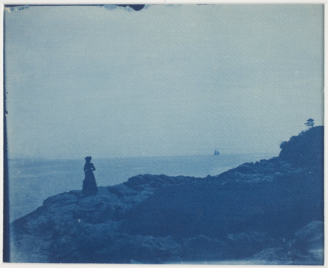 Woman Watching Schooner from a Rocky Promontory by American Photographer