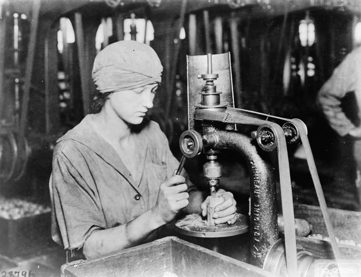Woman countersinking detonator tube hole and filling hole in hand grenade at Westinghouse Electric & Mfg. Co., East Pittsburgh, Pa., during World War I by American Photographer