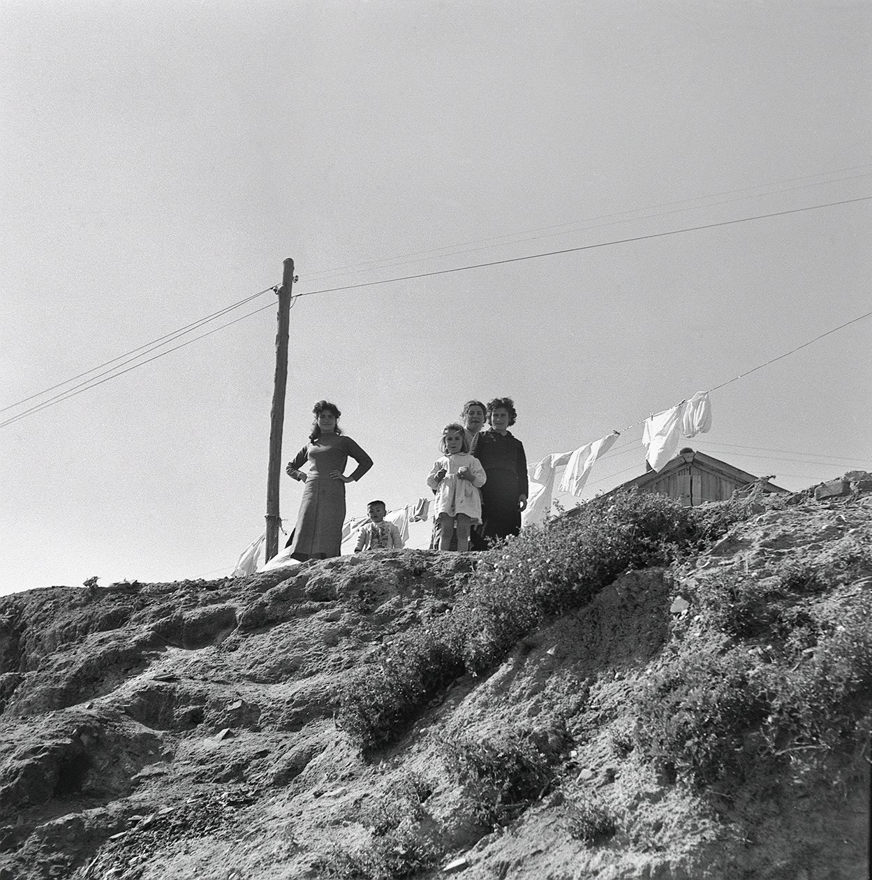 Women and Children Spreading Laundry by Ando Gilardi