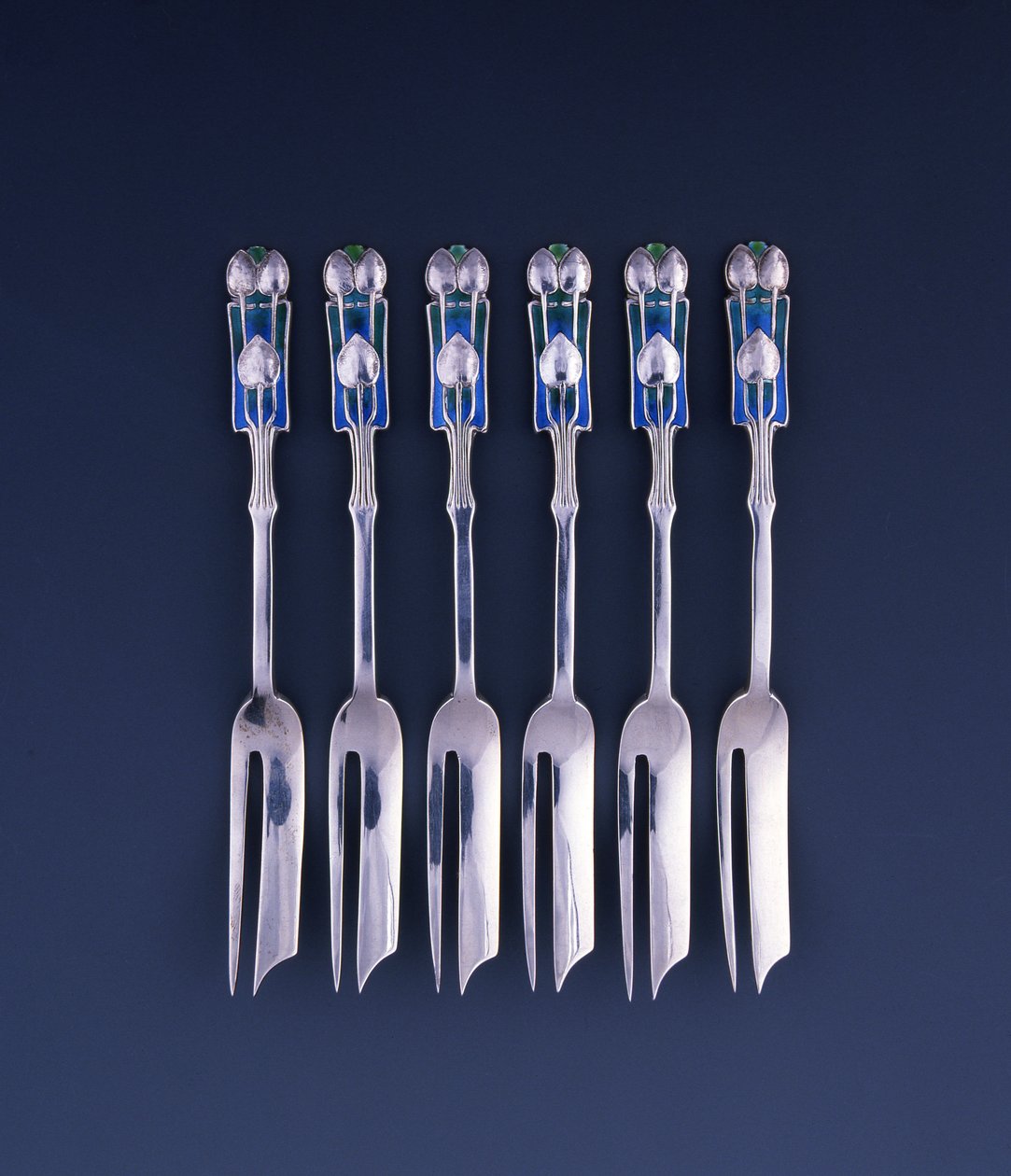 A Set of Six Liberty Silver and Enamel Pastry Forks by Archibald Knox