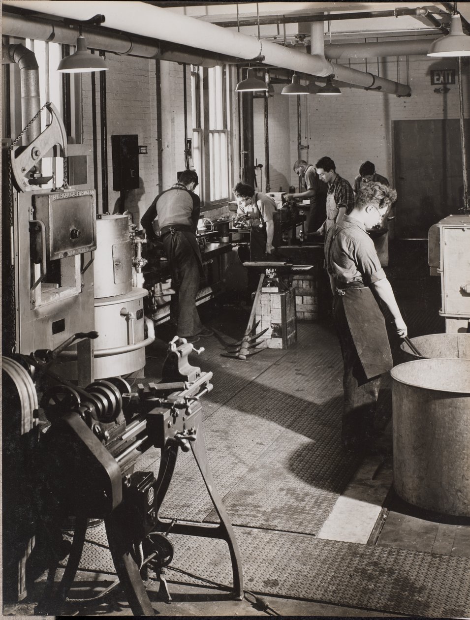 Six Men Working in a Welding Workshop by Arnold Eagle