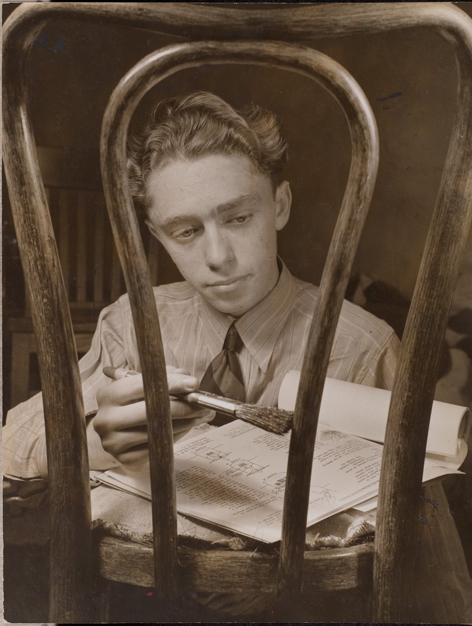 Young Man Paints the Back of a Wooden Chair by Arnold Eagle