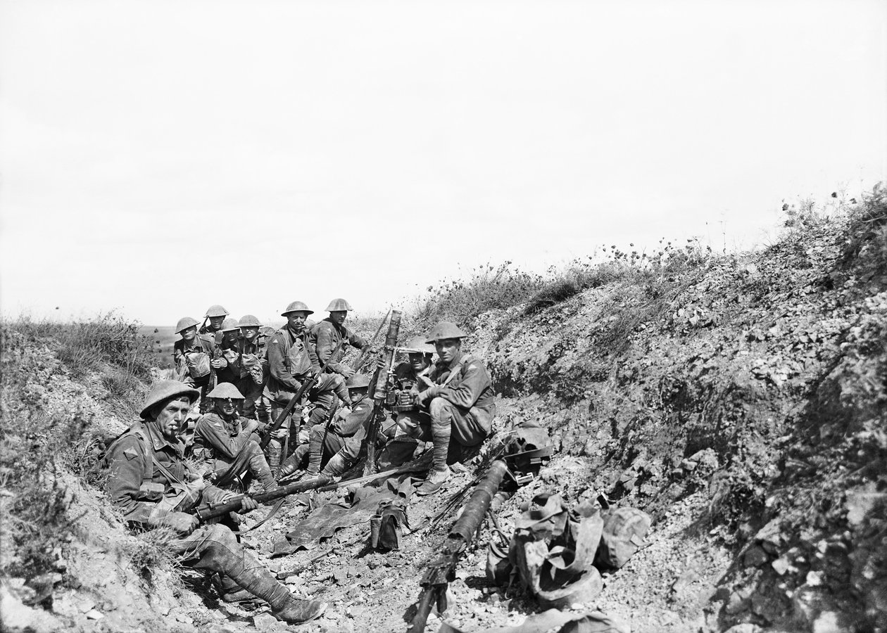 Lieutenant A. V. Sedgwick and some of his party from the 24th Battalion, awaiting the lifting of the artillery barrage on Mont St Quentin, photographed a few minutes before moving out of the trench by Australian Photographer