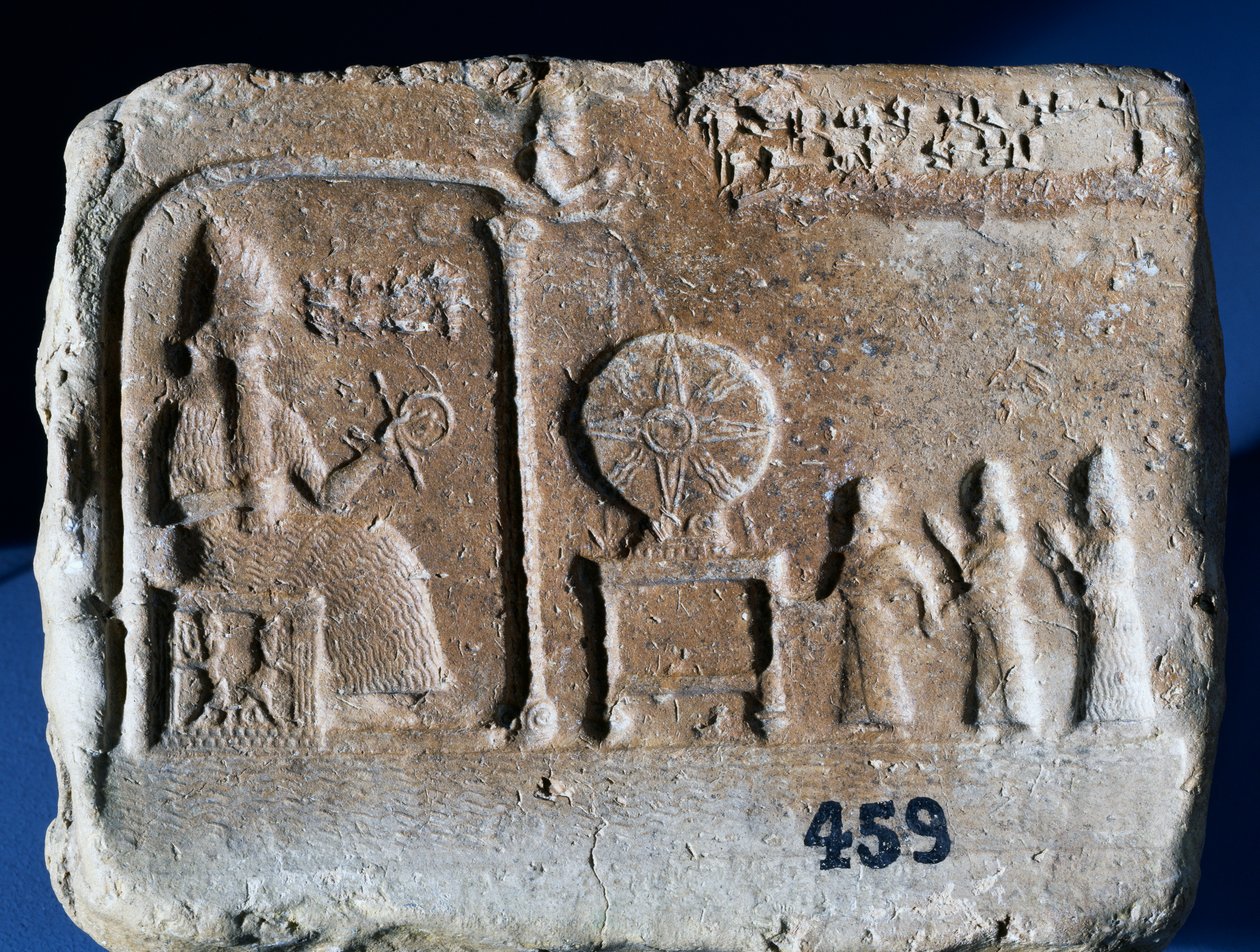 Votive tablet depicting Shamash, the sun-god of Sippar, seated in his shrine with the Babylonian king Nebopaliddin being led into the God