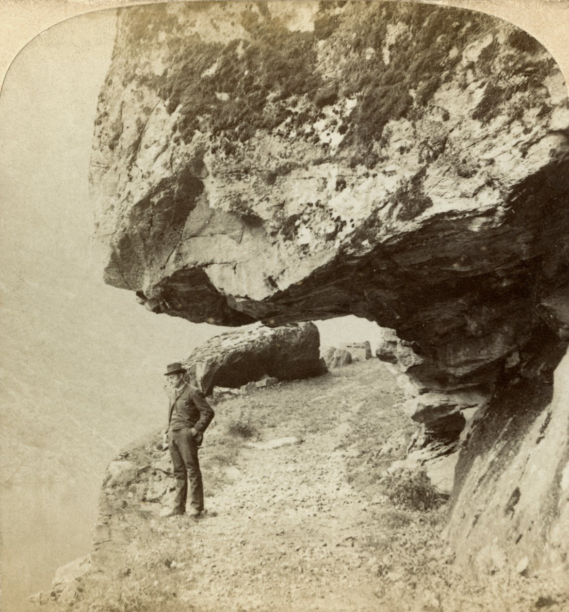 Man on a Cliff Overlooking Naeroyfjord, Sogne, Norway by Bert Underwood