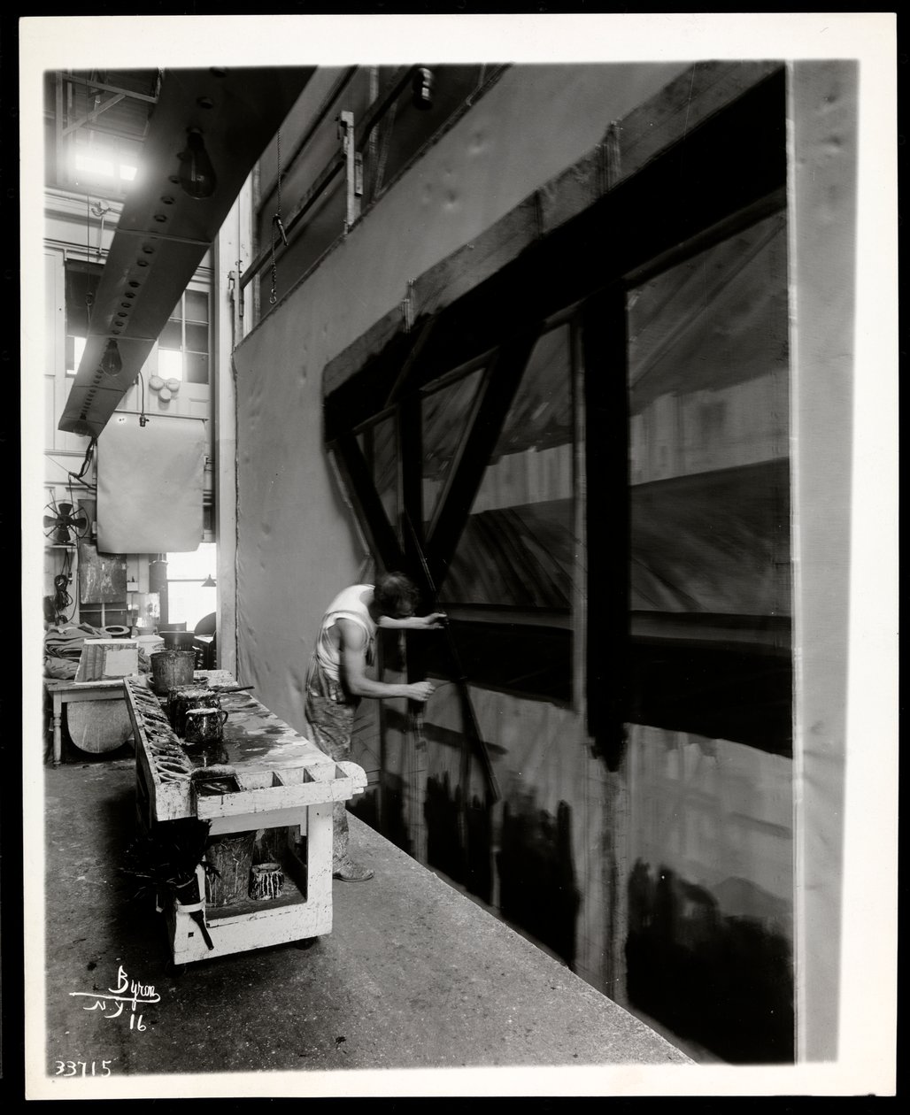 A Scenic Artist Painting a Flat in a Scene Shop, New York, 1915-6 by Byron Company