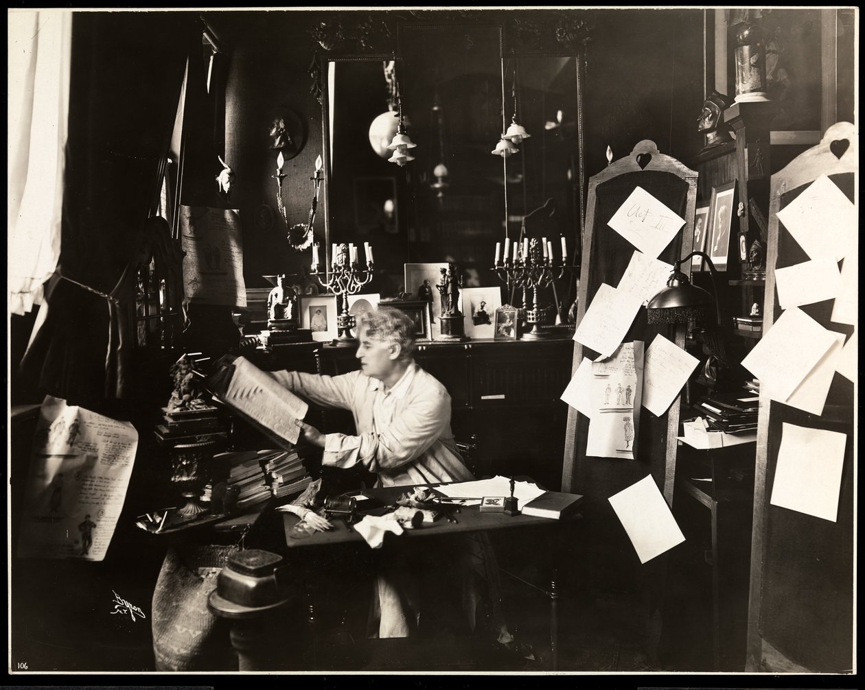 David Belasco in his study, leafing through a dictionary, 1909 by Byron Company