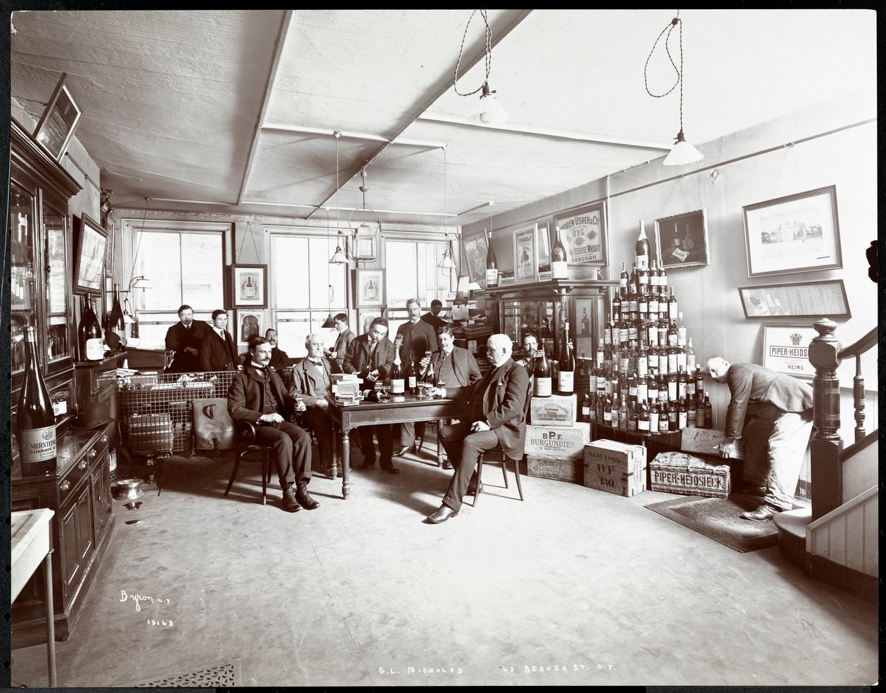 Group of men drinking wine at G.L. Nicholas, wine and liquor dealers, 43 Beaver Street, New York, 1895 by Byron Company