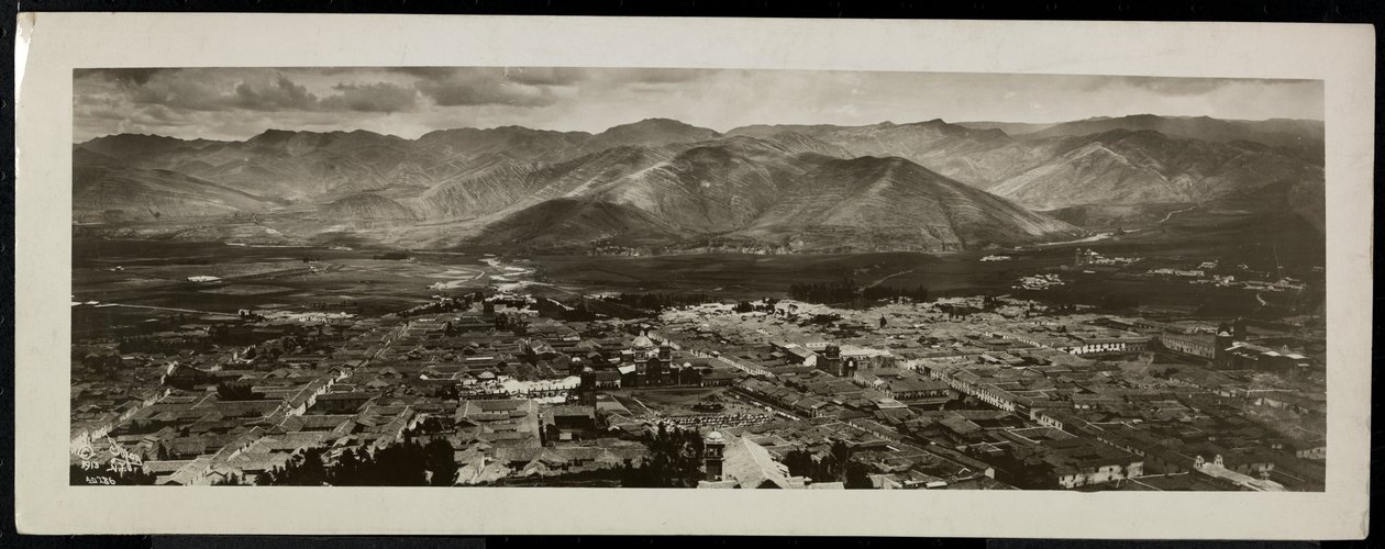 Panoramic view from above of a city, presumably on or near the Panama Canal with mountains beyond, 1913 by Byron Company