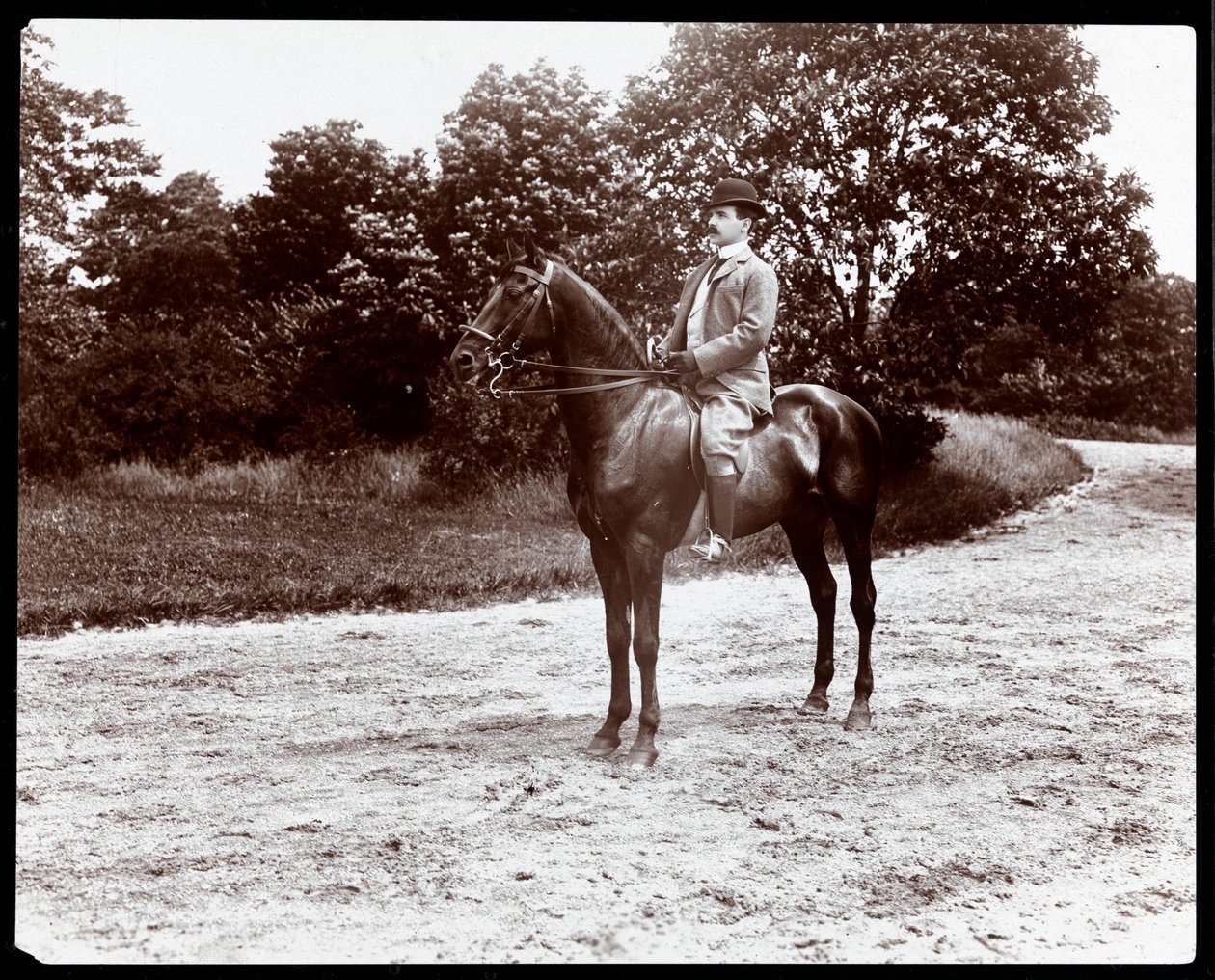 Portrait of Otto Kahn posed on a horse on the bridle path in Central Park, New York by Byron Company