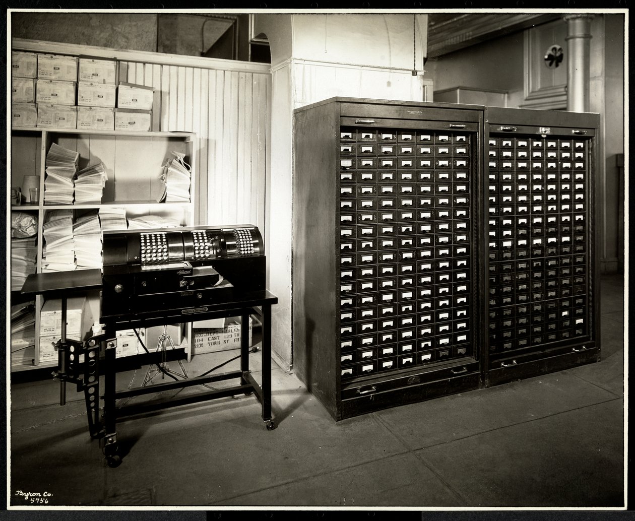 Possibly an adding machine and a filing cabinet with small drawers in the office of the Carolyn Laundry at 111 East 128th Street, East Harlem, New York, 1929 by Byron Company
