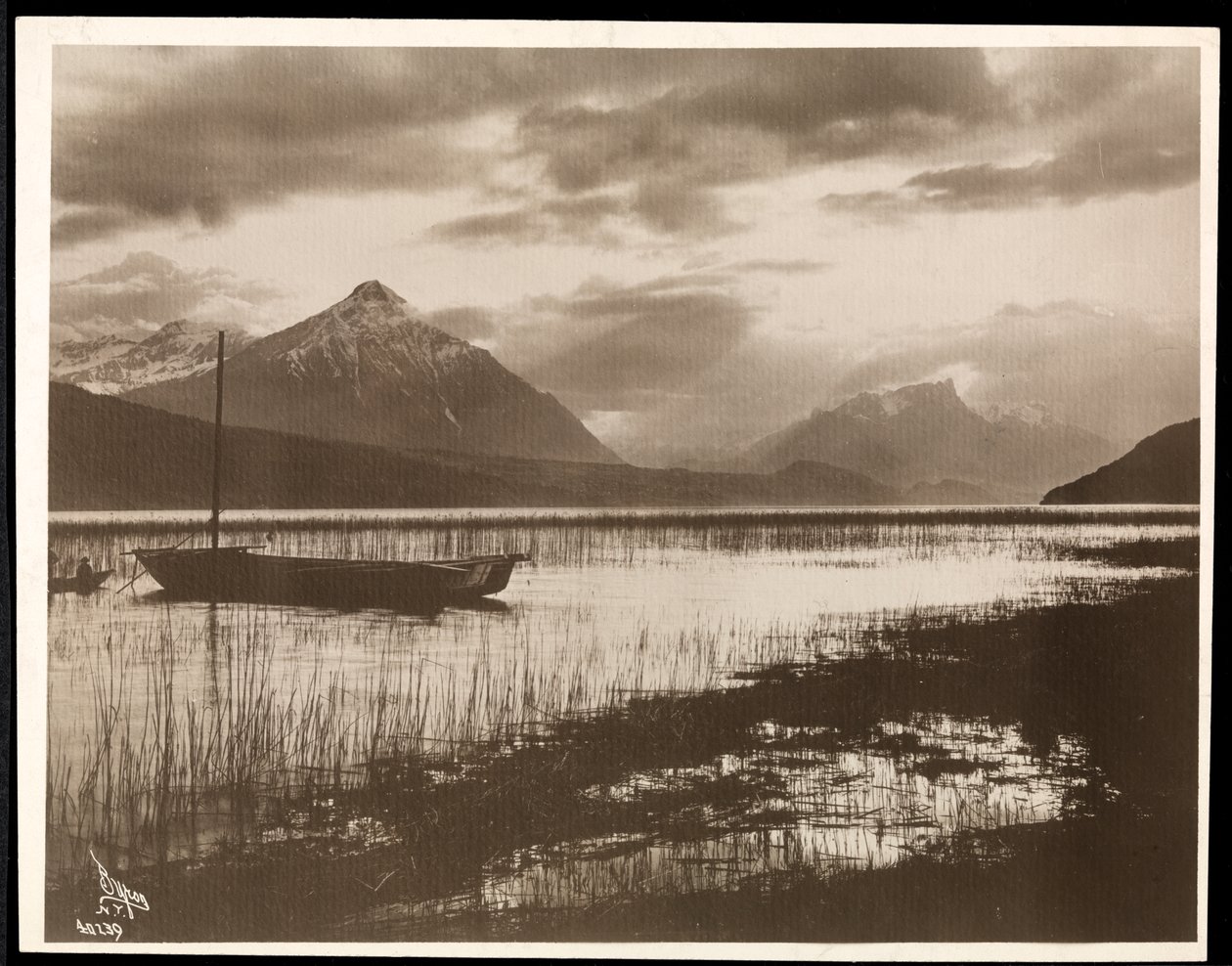 View of a lake and a boat during the construction of the Panama Canal by Byron Company