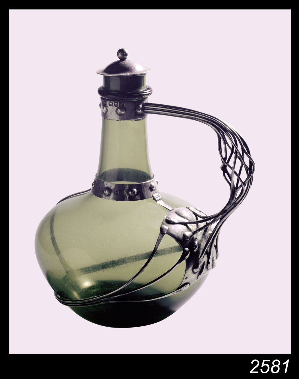 Silver-mounted green glass decanter with makers mark for the Guild of Handicraft, 1901 by Charles Robert Ashbee