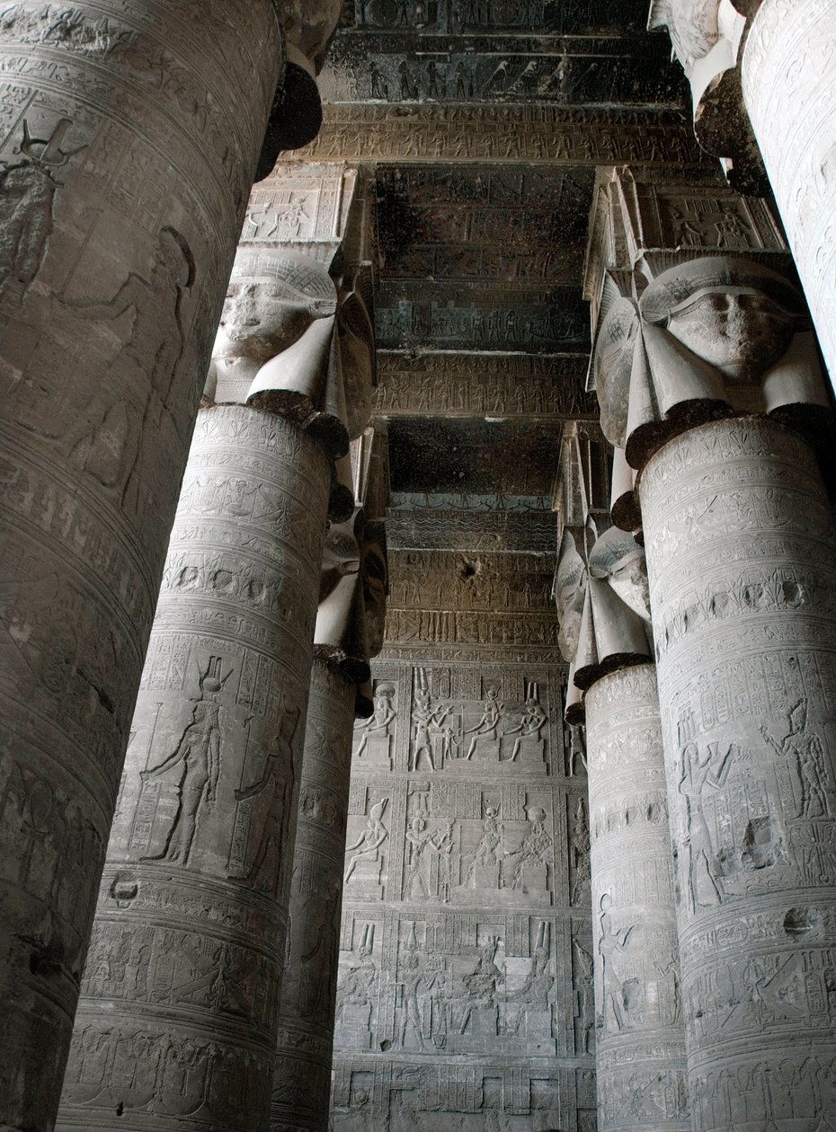Partial view of the hypostyle room with columns decorated with the representation of the goddess Hathor. Temple of Hathor, Denderah, Egypt by Egyptian Ptolemaic Period