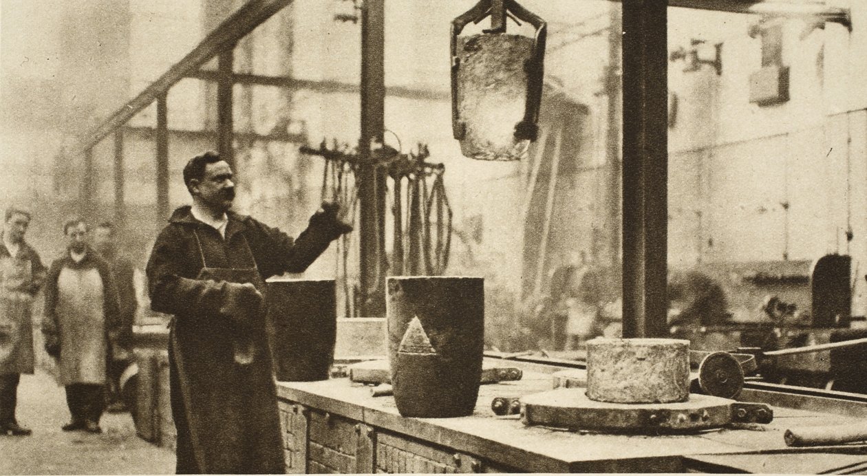 Making money: pots of liquid metal being handled in the melting room by English Photographer