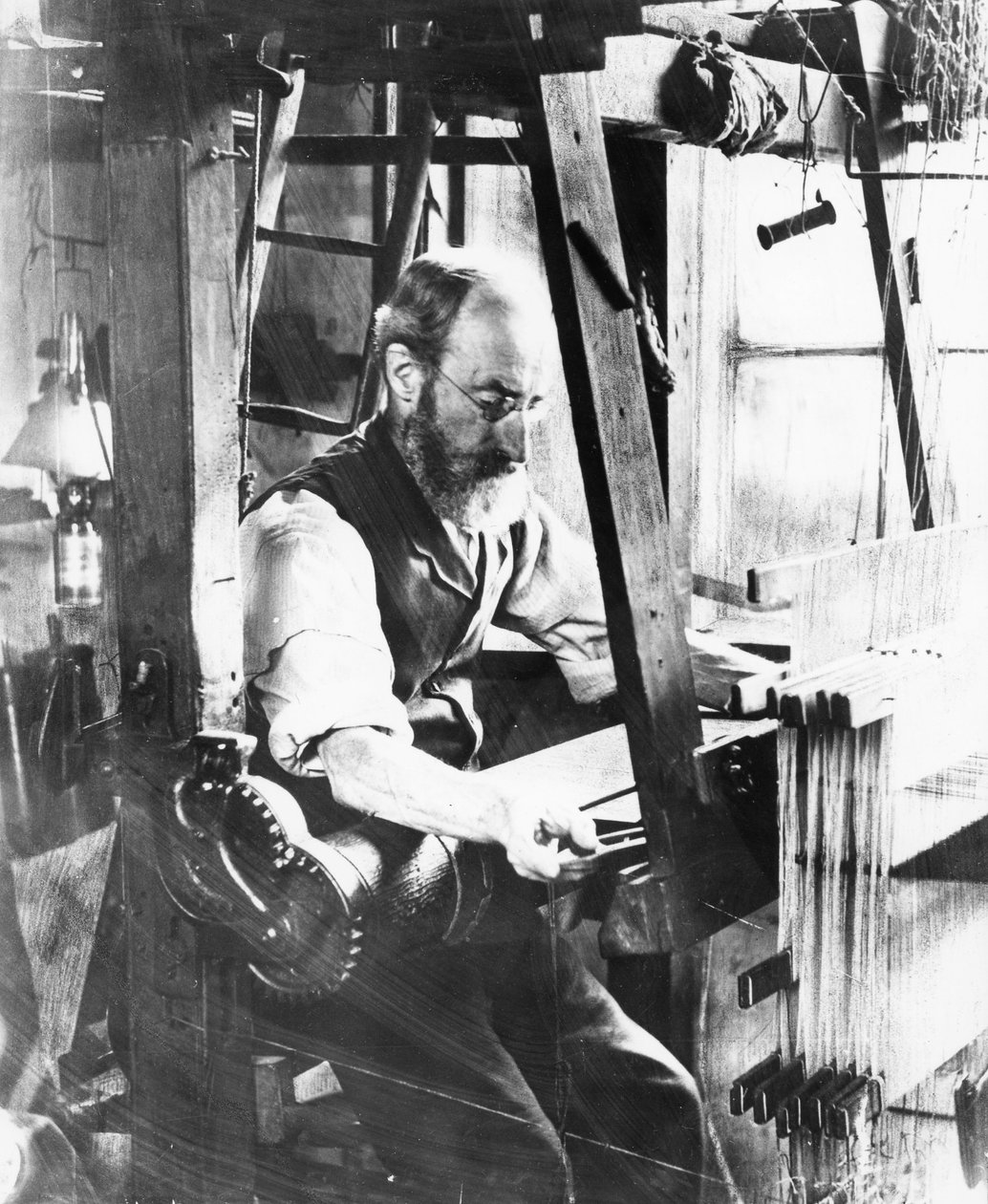 Man working at a handloom by English Photographer