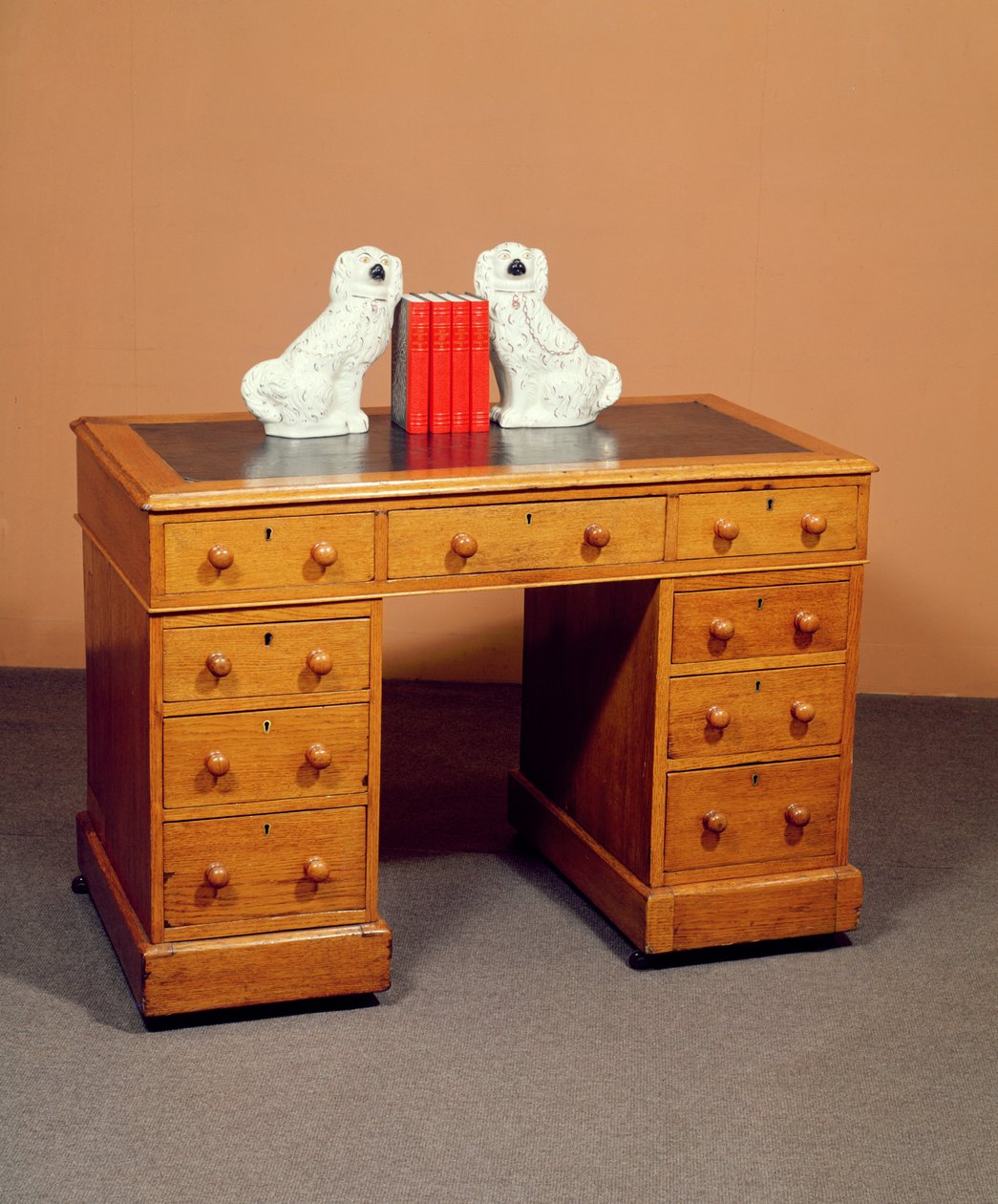 Victorian kneehole desk and a pair of Staffordshire dogs with copper lustre decoration, c.1850 by English School