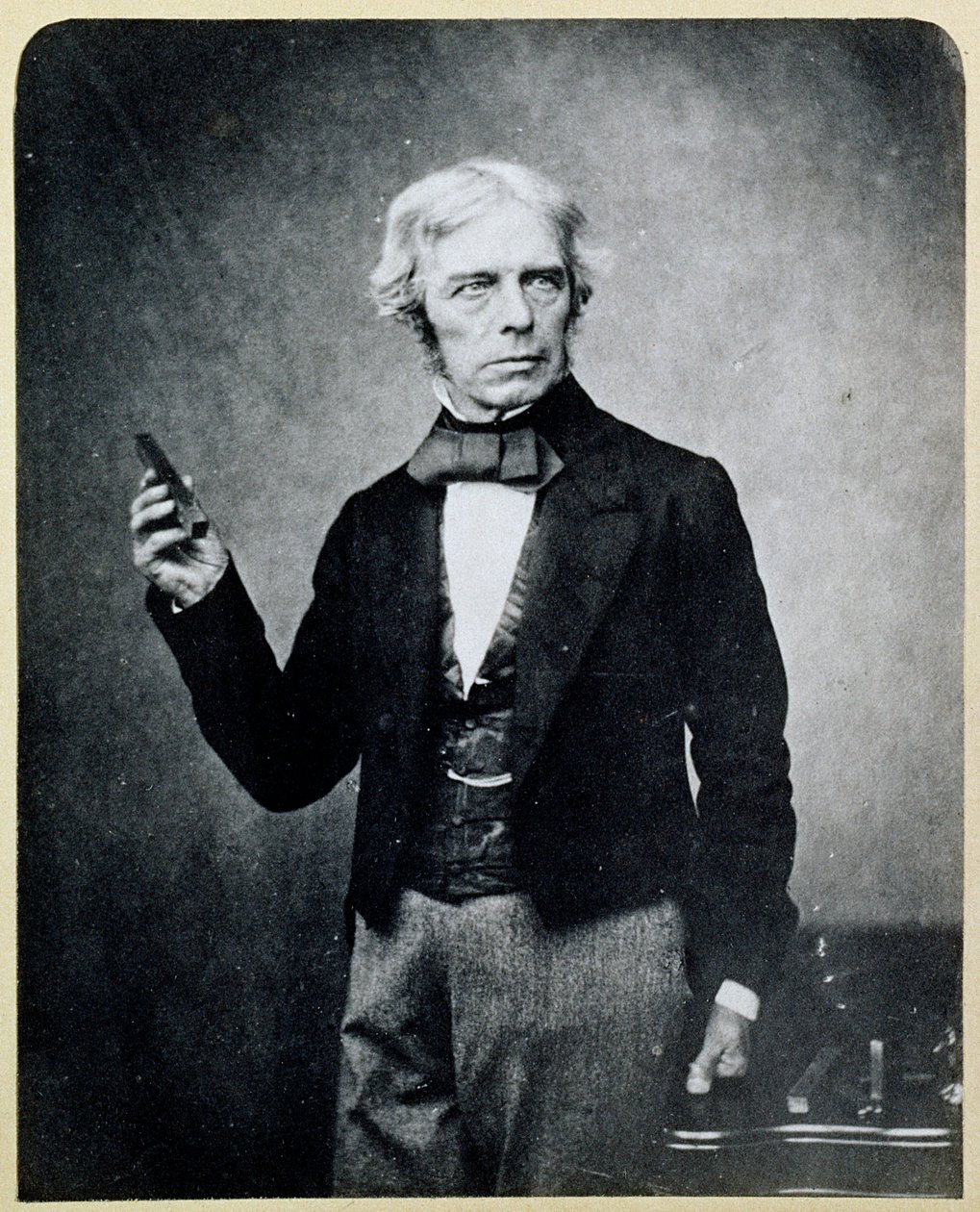 Michael Faraday holding a Bar Magnet by English Photographer