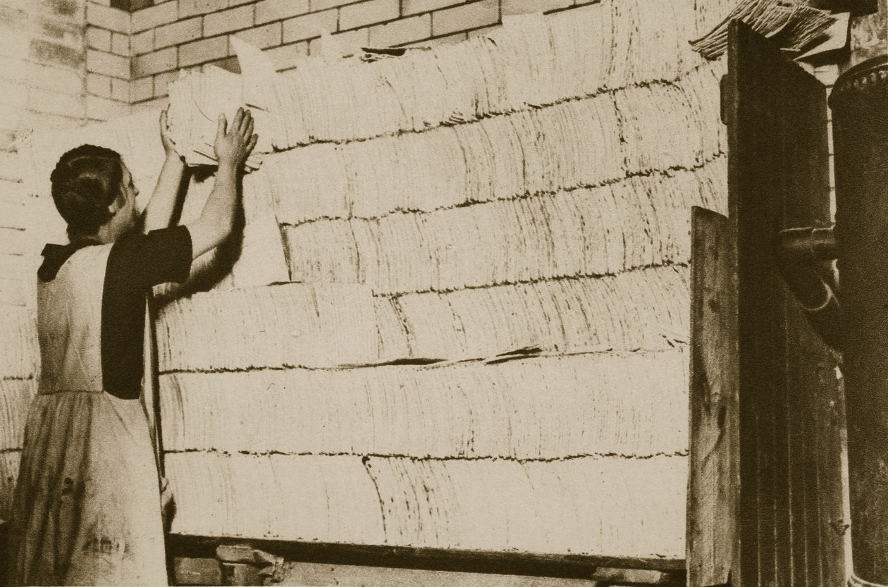 Stacking unleavened bread for the Passover in a Hebrew bakery by English Photographer