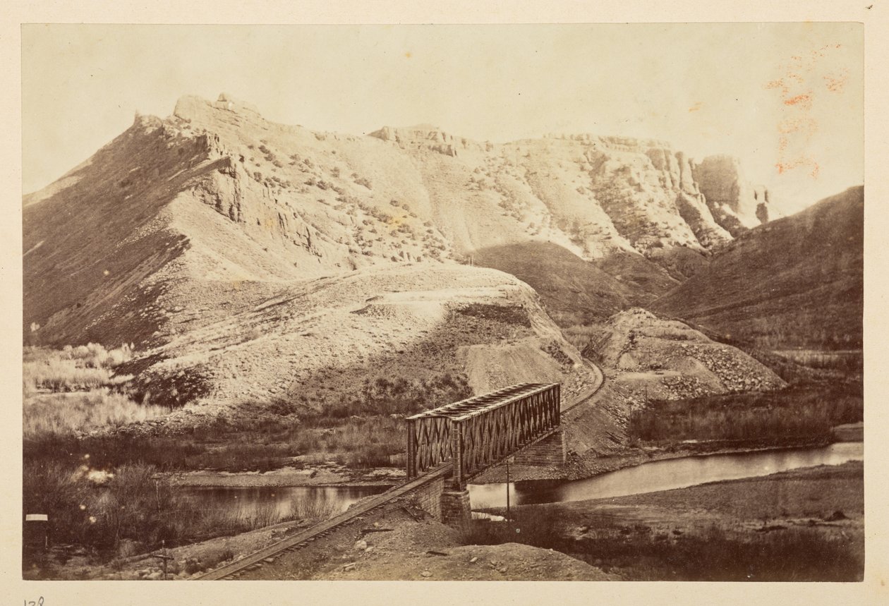 Views on the Pacific Railway, of railway track crossing a river on a girder bridge, with mountains beyond by English Photographer