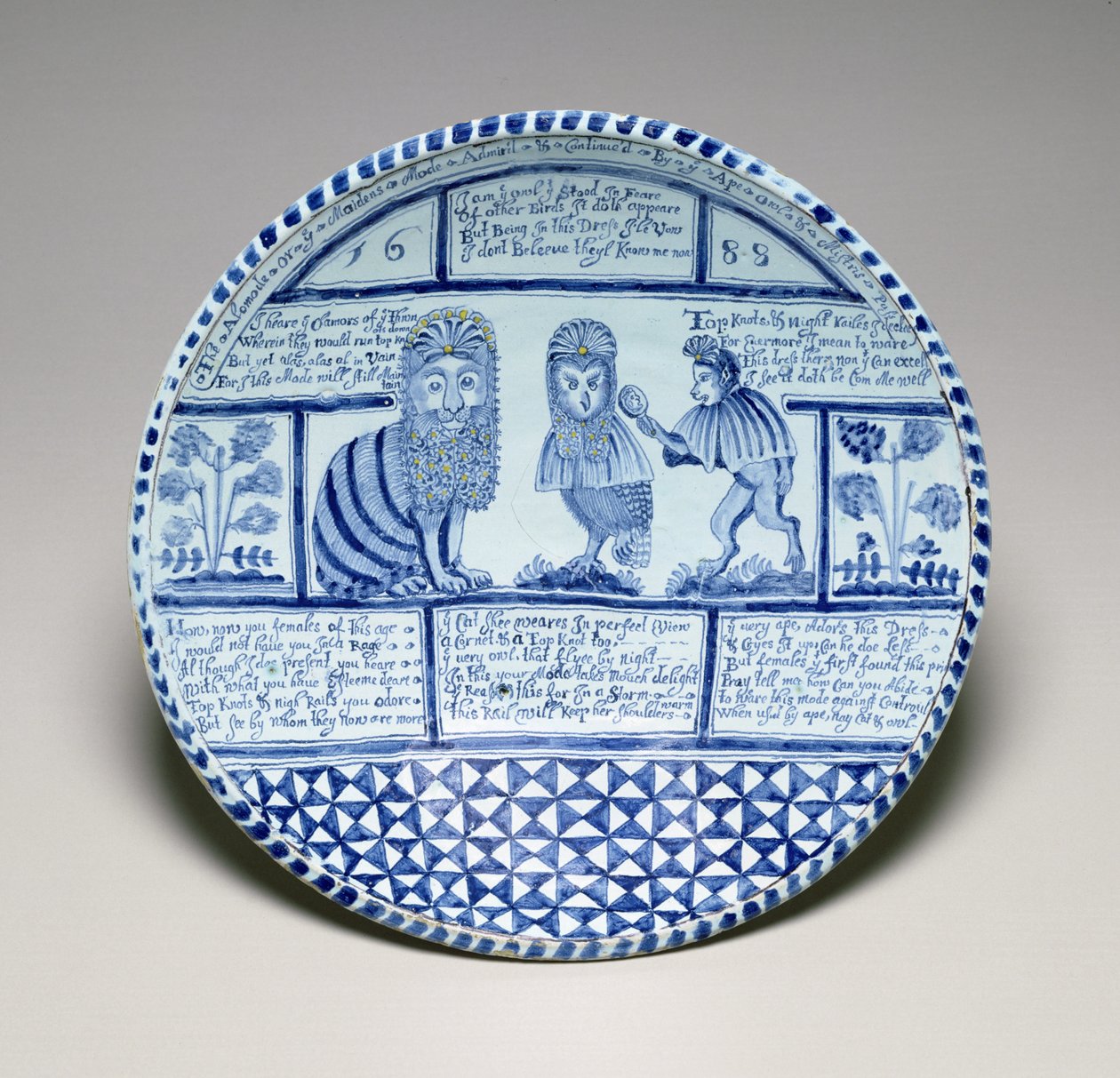 Dish with a Cat, an Owl and a Monkey looking in a mirror by English School