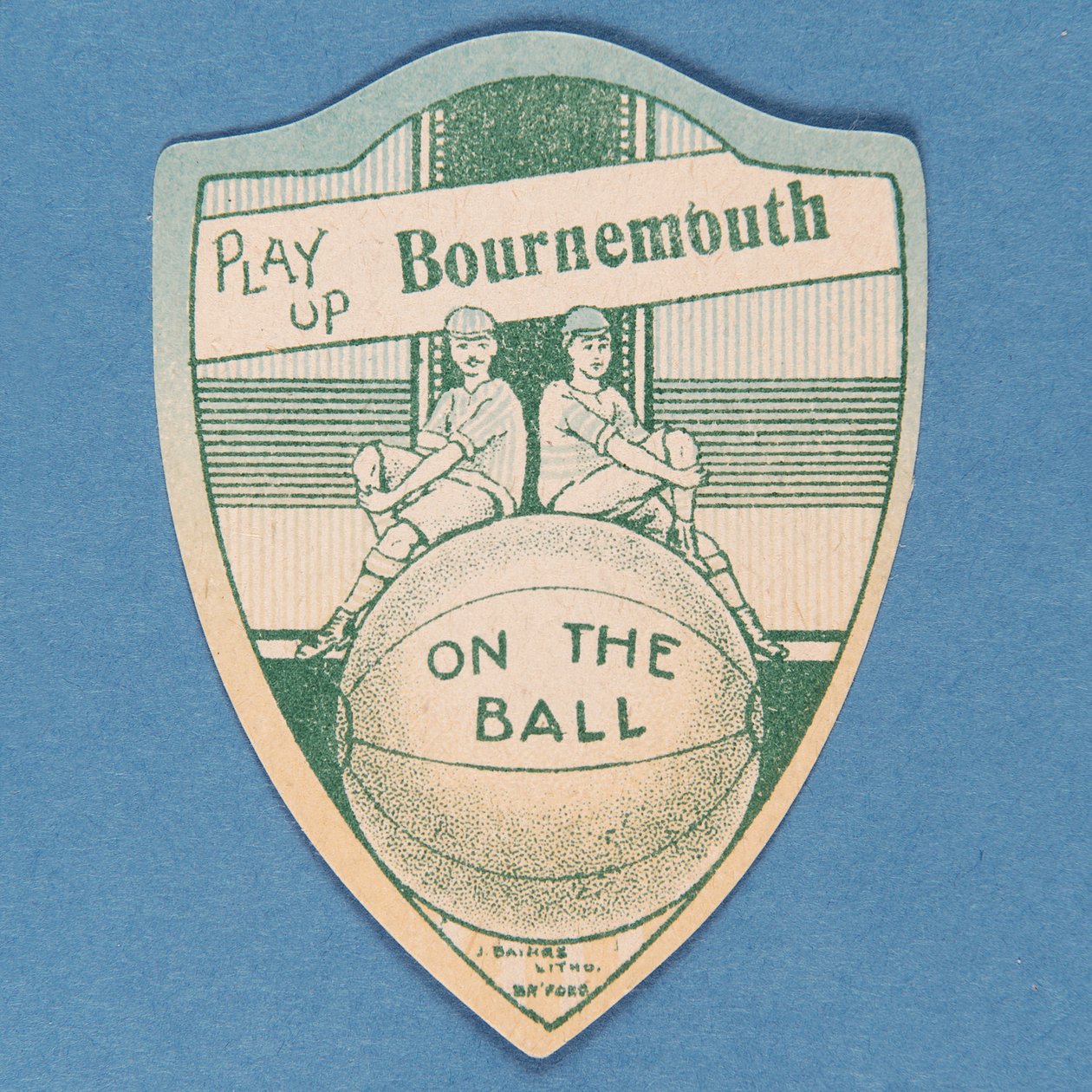 Play Up Bournemouth, Baines Card in the Shape of a Shield and Two Footballers Sitting on Top of a Large Football, 1888-89 by English School