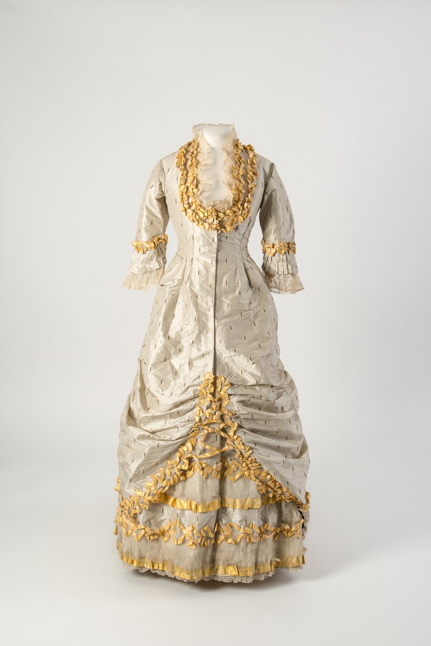 Princess line evening dress of grey and white narrow striped silk trimmed with net covered yellow silk taffeta ruched ribbon by English School