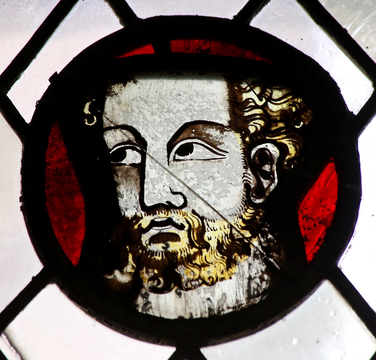 Window s6 depicting a reset fragment with a head by English School