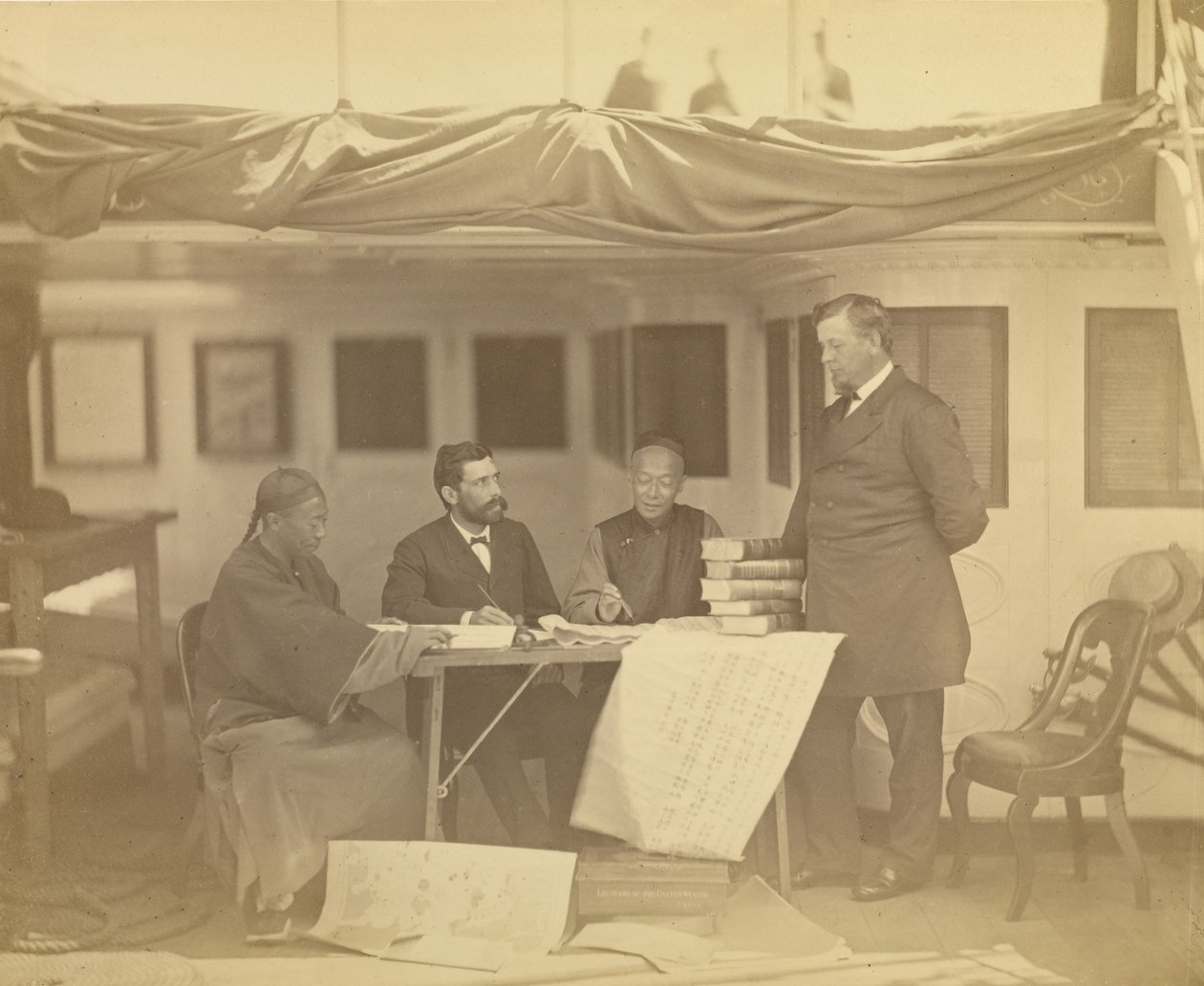 Chinese Interpreters with Secretary Drew and Minister Low in Cabin of the U.S. Flag Ship Colorado by Felice Beato