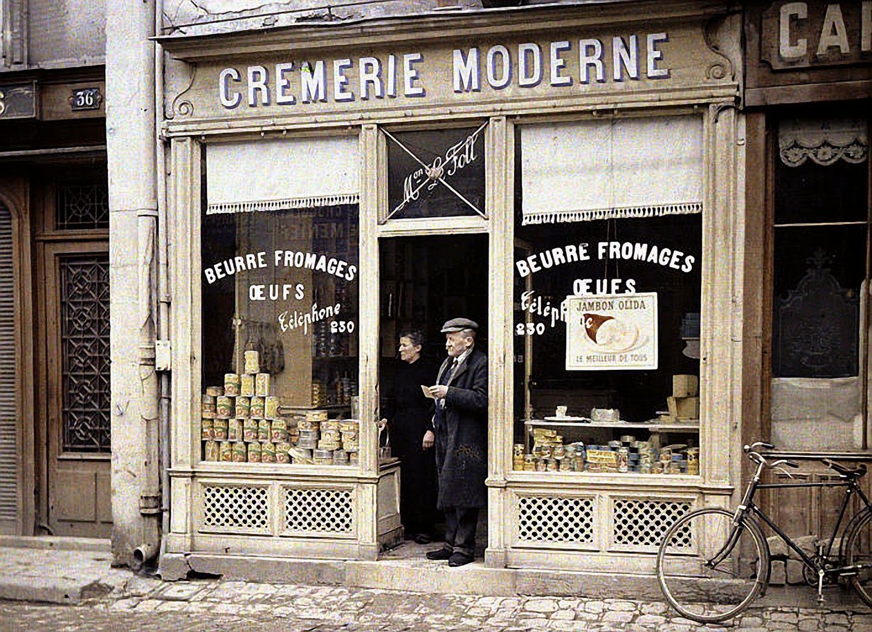 Couple on the doorstep of Le Foll dairy, Reims, Marne, France, 1917 by Fernand Cuville