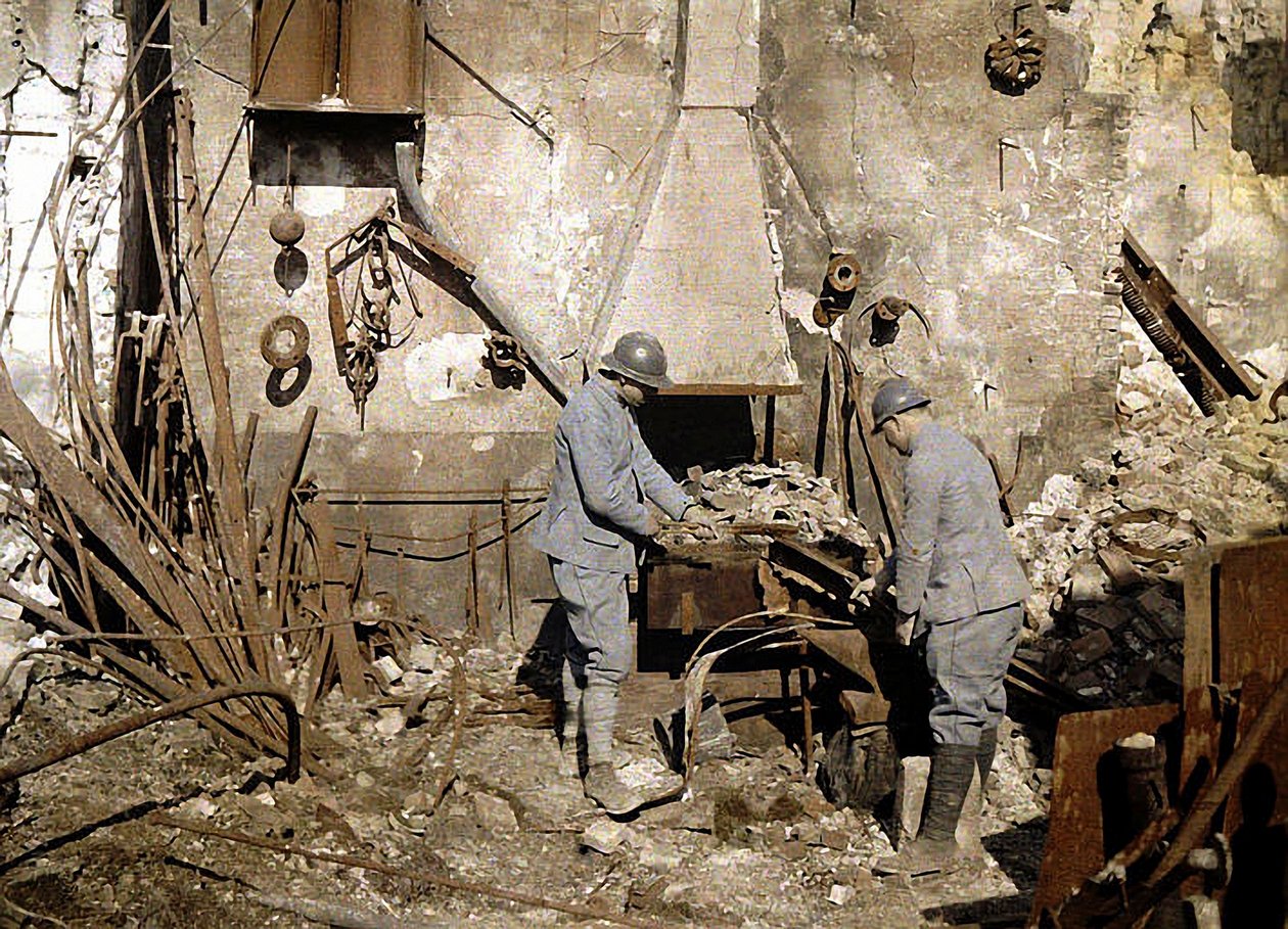 Two French soldiers working in a forge destroyed by grenades, Reims, France, 1917 by Fernand Cuville
