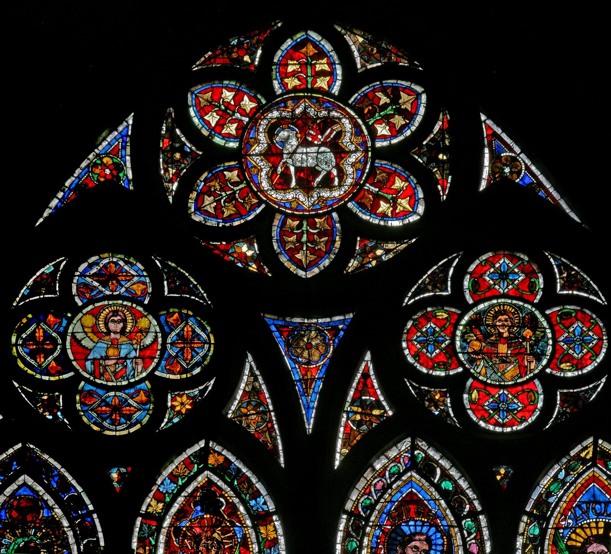 Window w202 depicting the tracery lights with two angels and the Agnus Dei by French School
