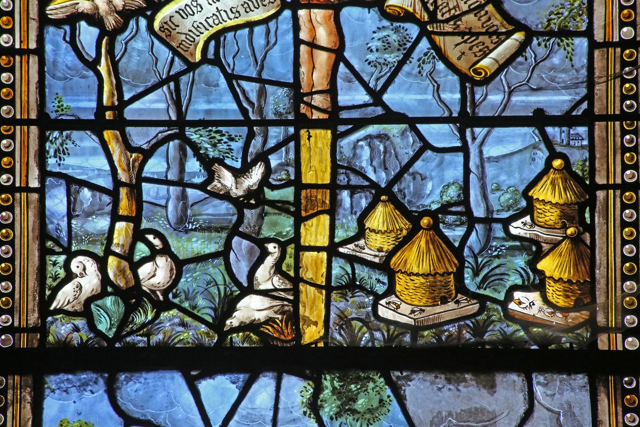 Window depicting Virgil-inspired country scenes beneath Christ on Cross