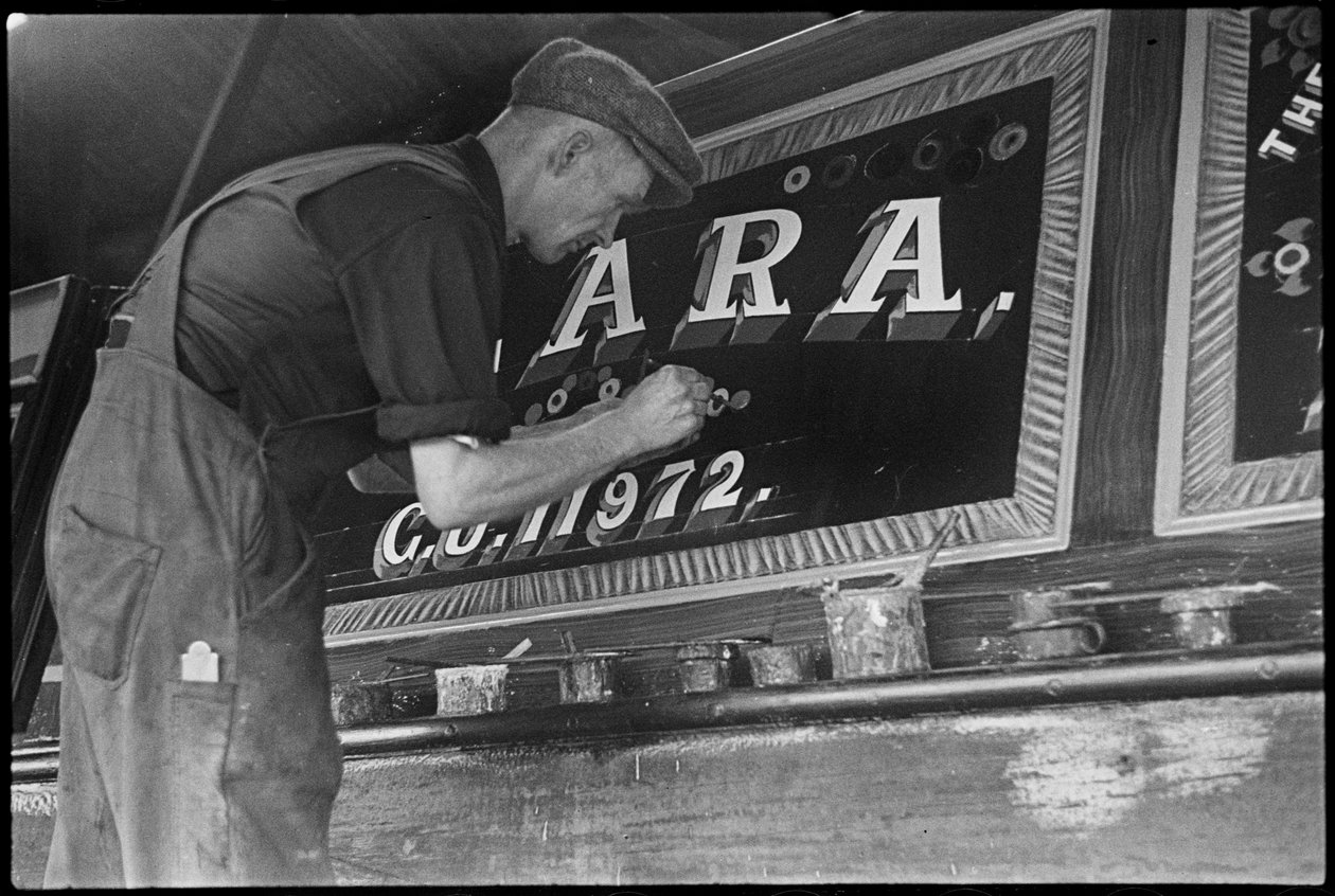 Frank Jones painting the name panel on a barge, 20th century by George R. Long