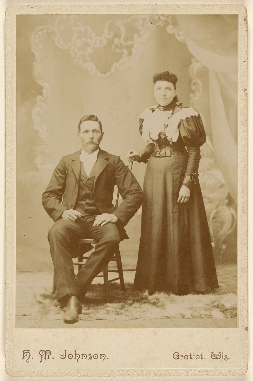 Unidentified couple: man with moustache seated, woman standing by H. M. Johnson