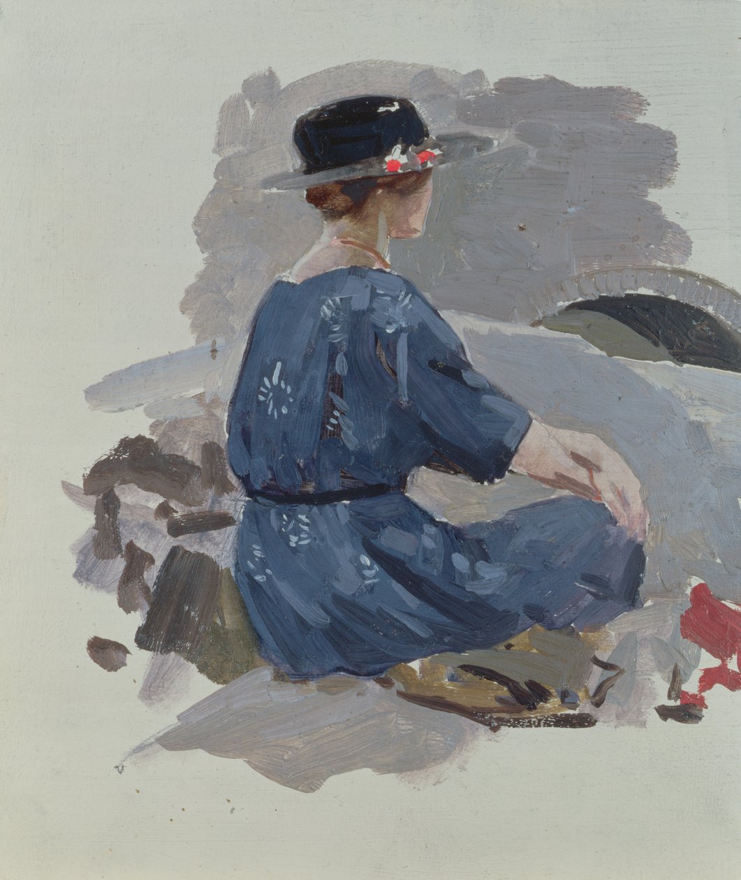 Woman in a blue dress and wide brimmed hat sitting upon rocks