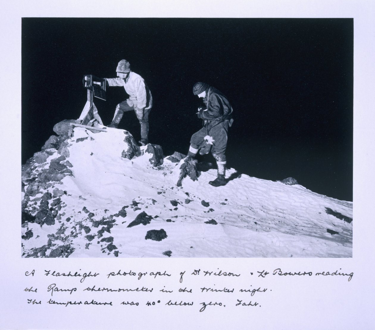 A flashlight photograph of Dr Wilson and Lt Bowers reading the Ramp thermometer. The temperature was 40 degrees below zero Fahrenheit, from 