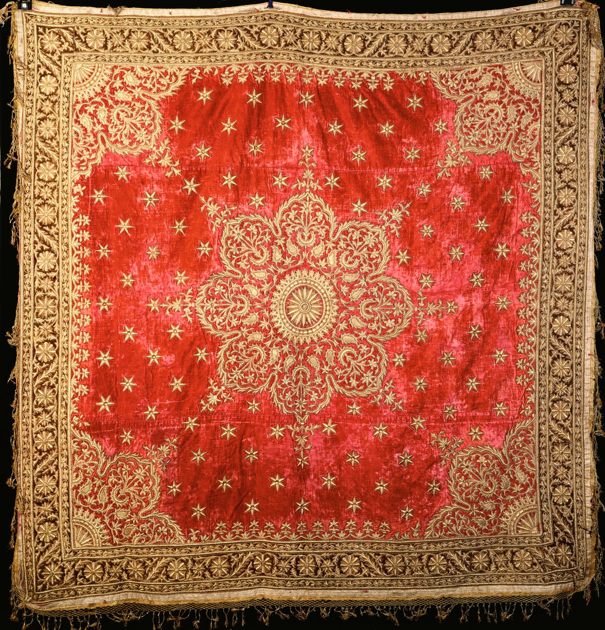A Scarlet Velvet Floor Cover with Green Velvet Border, Densely Embroidered in Gilt Couched Gilt Thread by Indian School