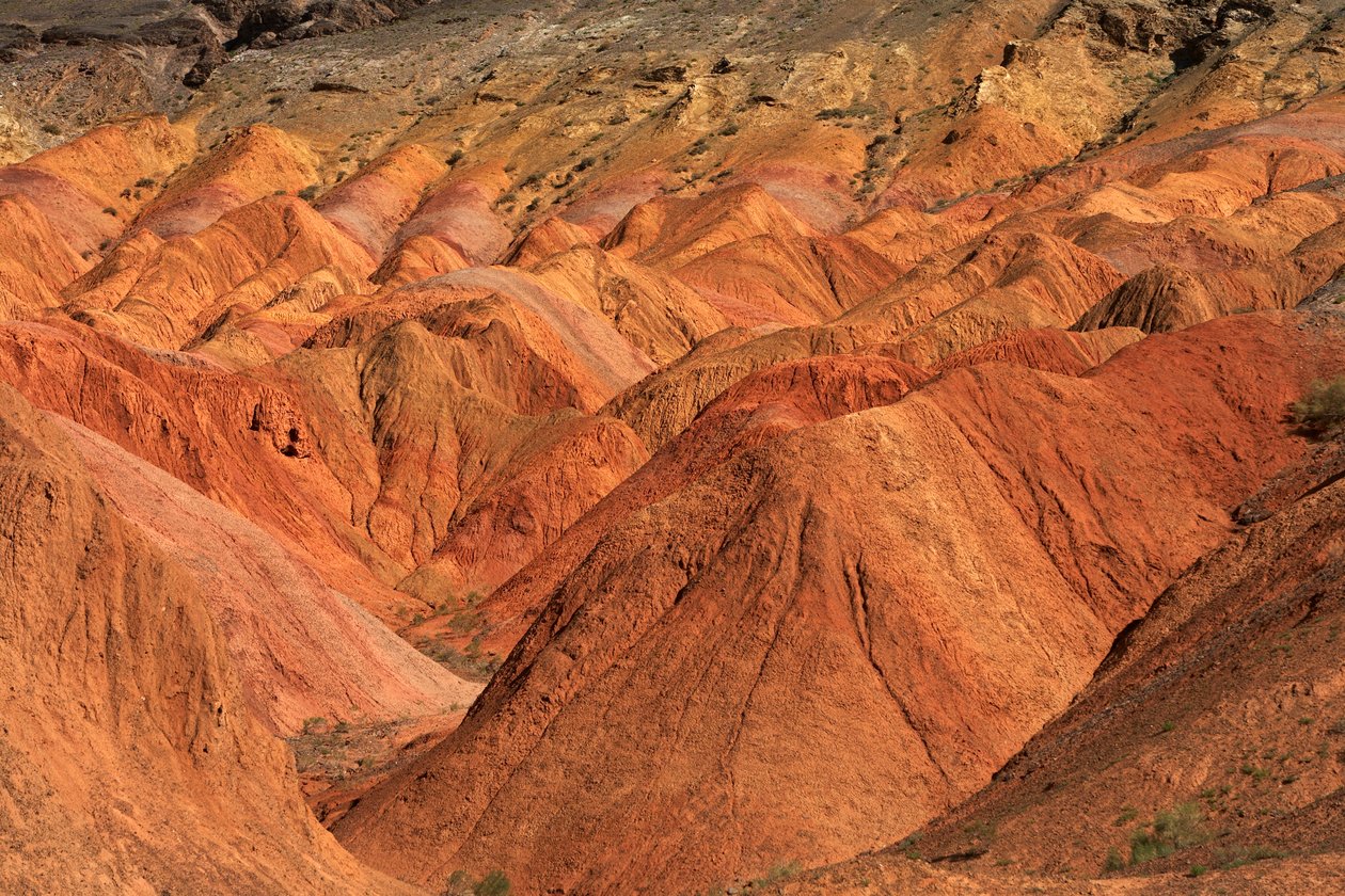 At the colored rocks near the campsite at Wu Cai Wan in the Gobi desert, Xinjiang..., 2007 by Ira Block