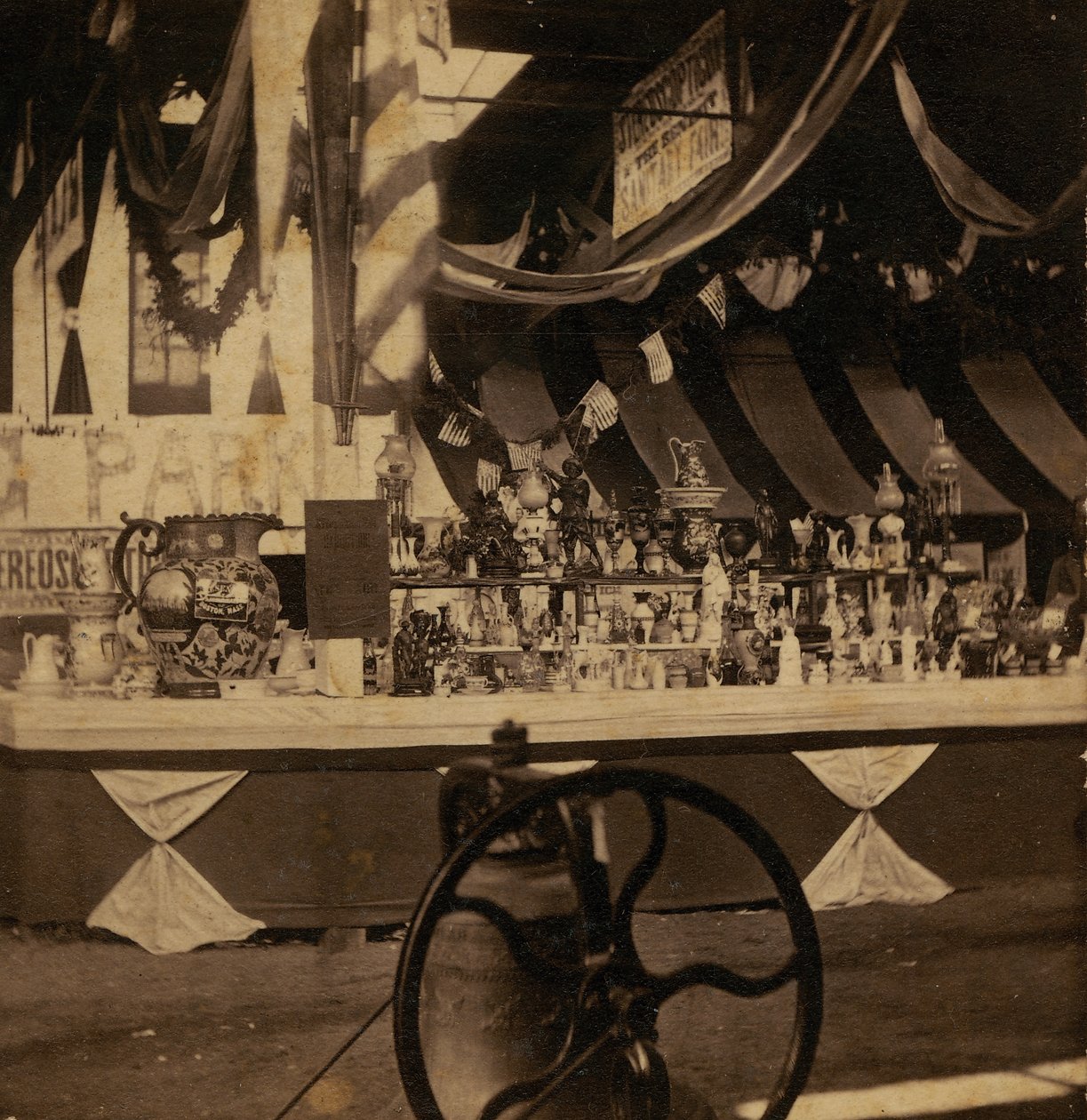 Half-view Stereograph of Table with Various Pieces of Merchandise by J.A. Scholten