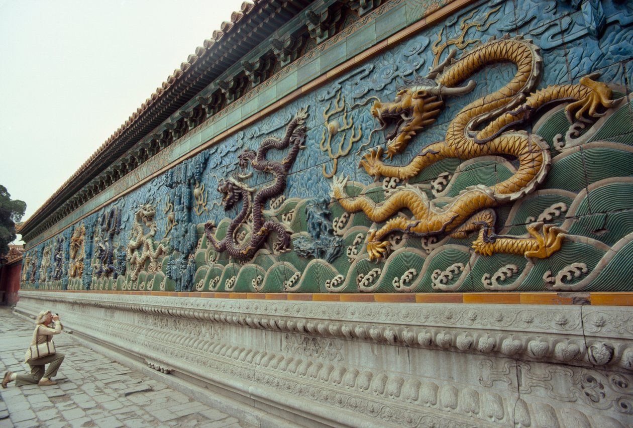 Woman photographs the Nine-Dragon Screen in Beihai Park, Beijing by James L Stanfield